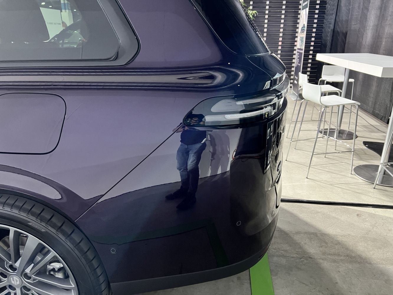 Close-up of rear quarter panel, taillight strip, and alloy wheel design