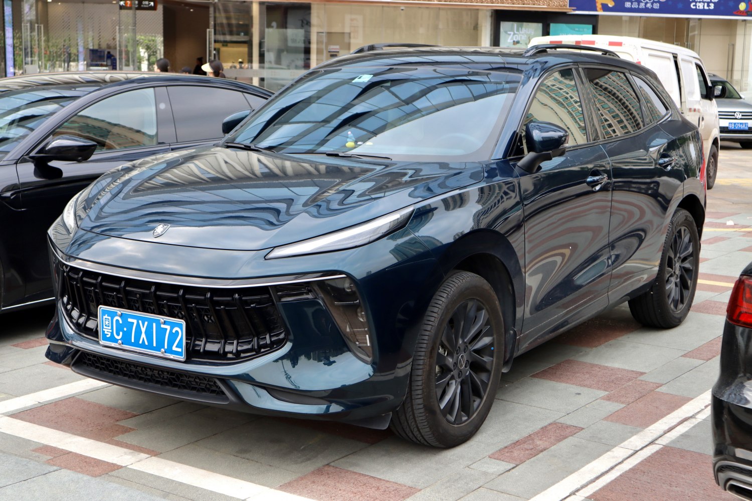 Front and side view with vertical grille slats and slim headlights
