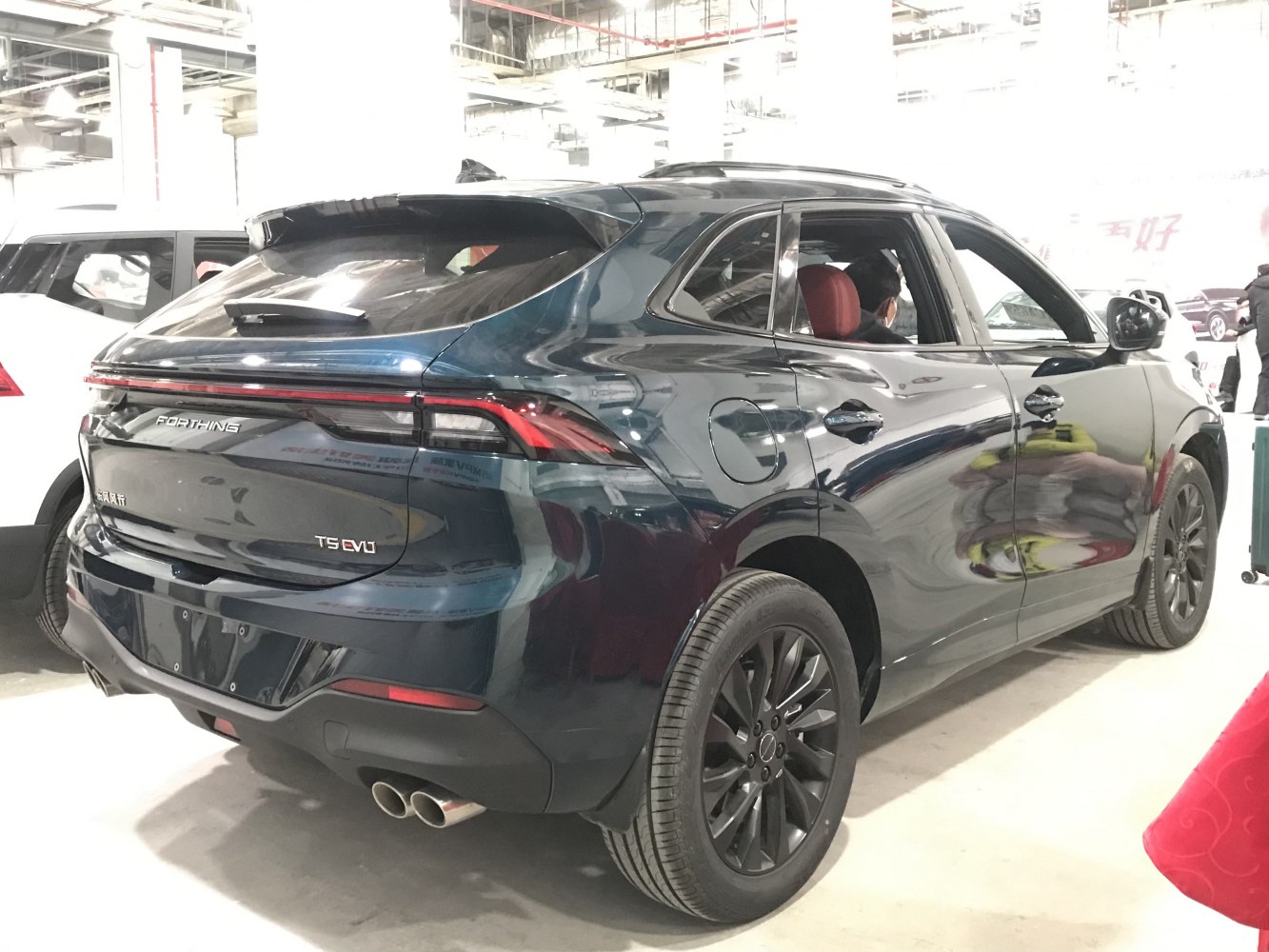 Rear and side view with dual exhaust and black rims