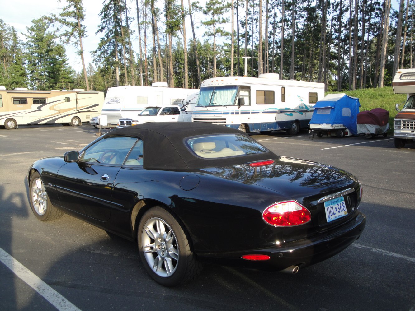 Black soft-top convertible rear view with rounded tail lights and sleek body lines