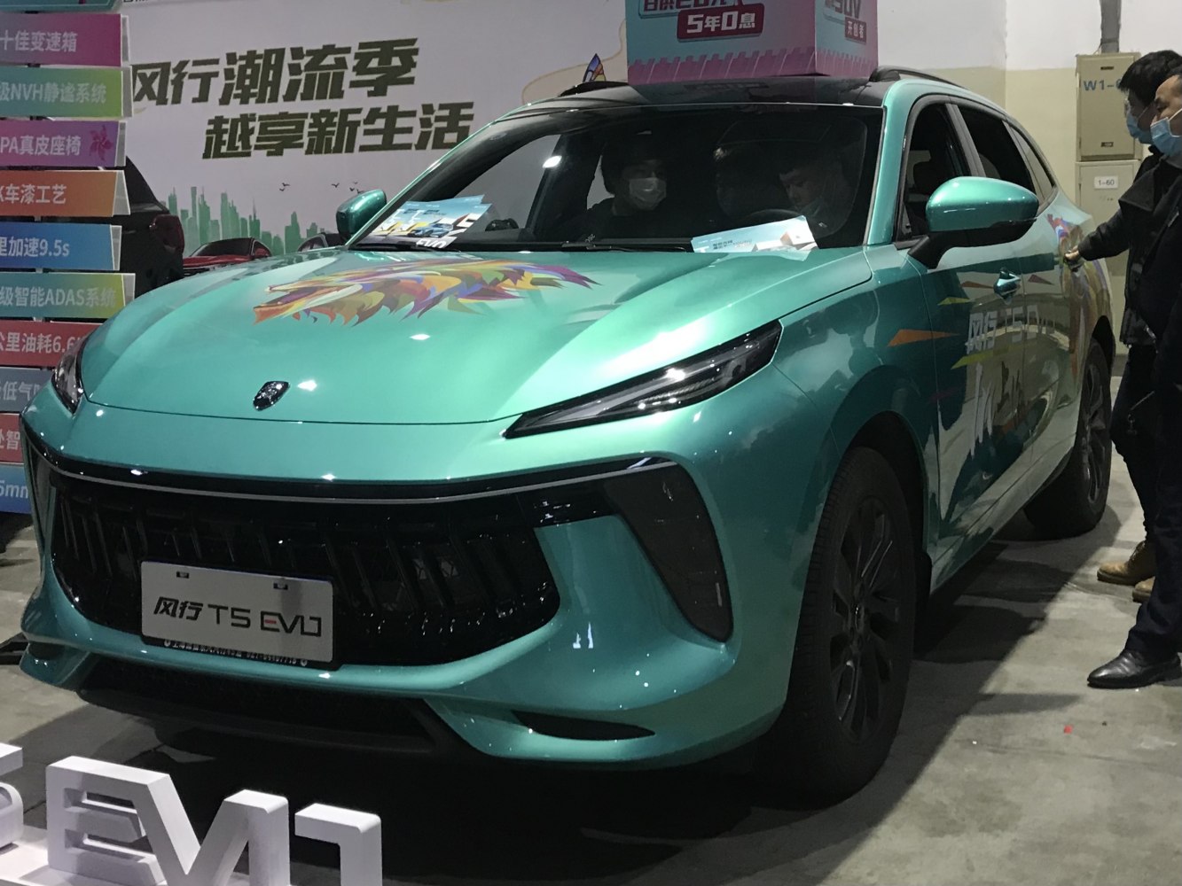 Front view with black grille and slim LED headlights, teal color with vibrant hood design