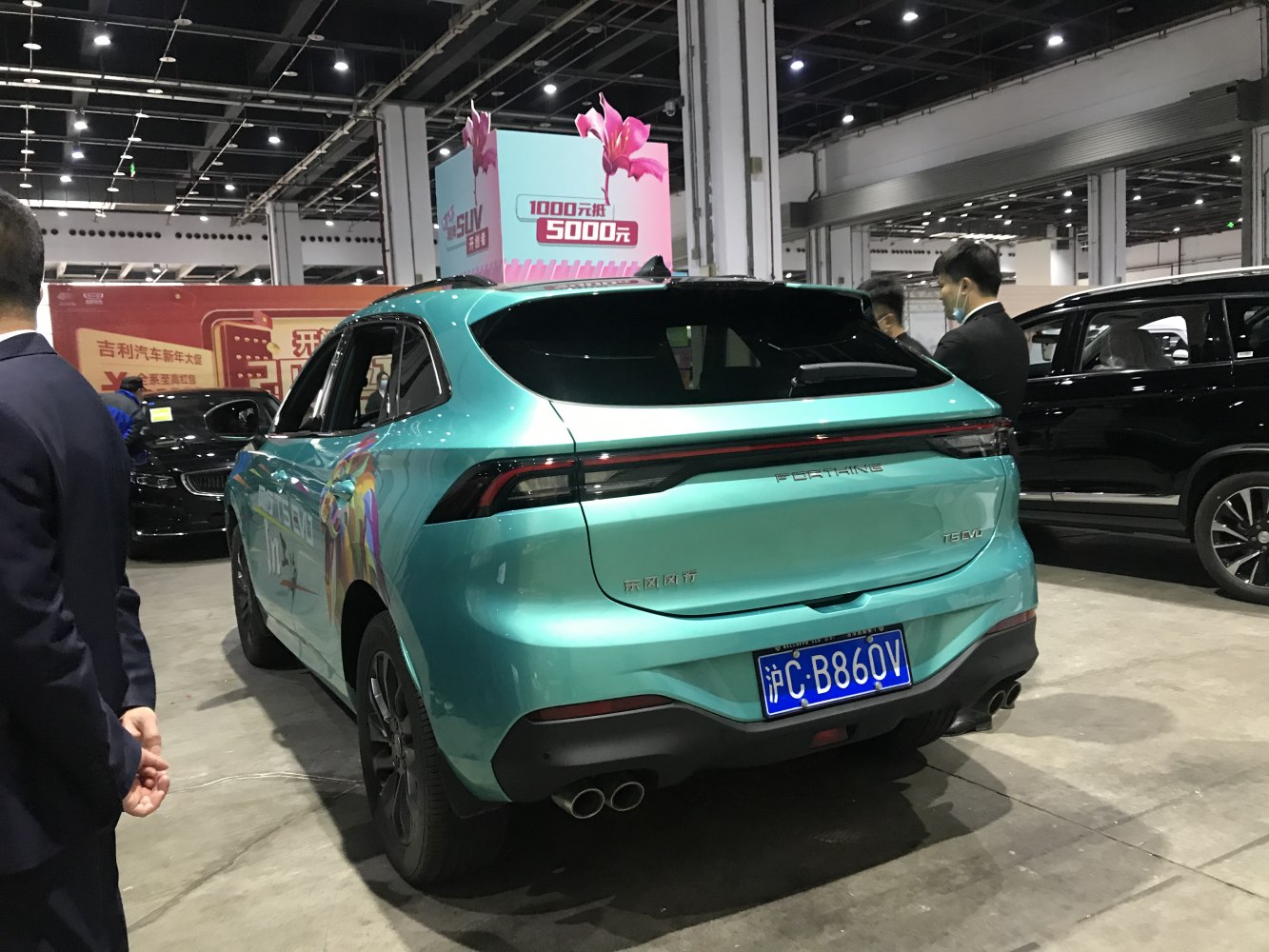 Modern SUV rear design with dark tinted windows and dual exhaust.