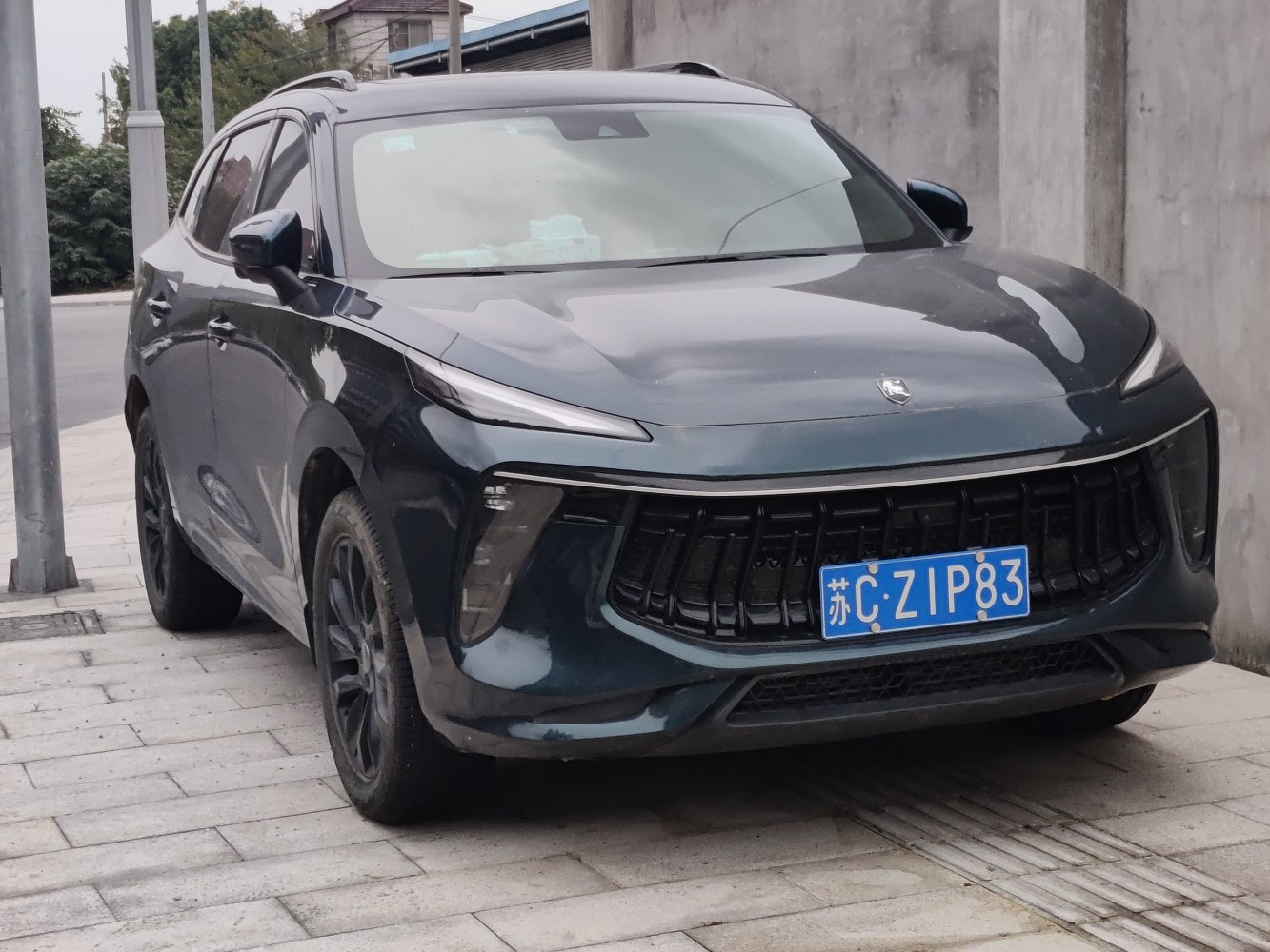 Slim LED headlights and large vertical black front grille on an SUV.
