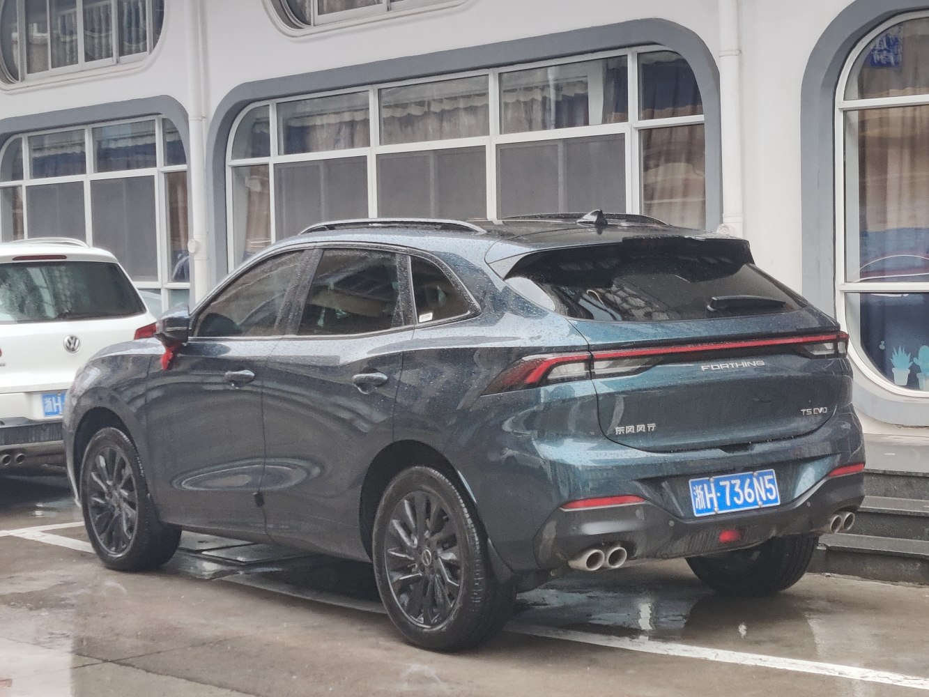 Rear angle view with quad exhaust and sporty rear design