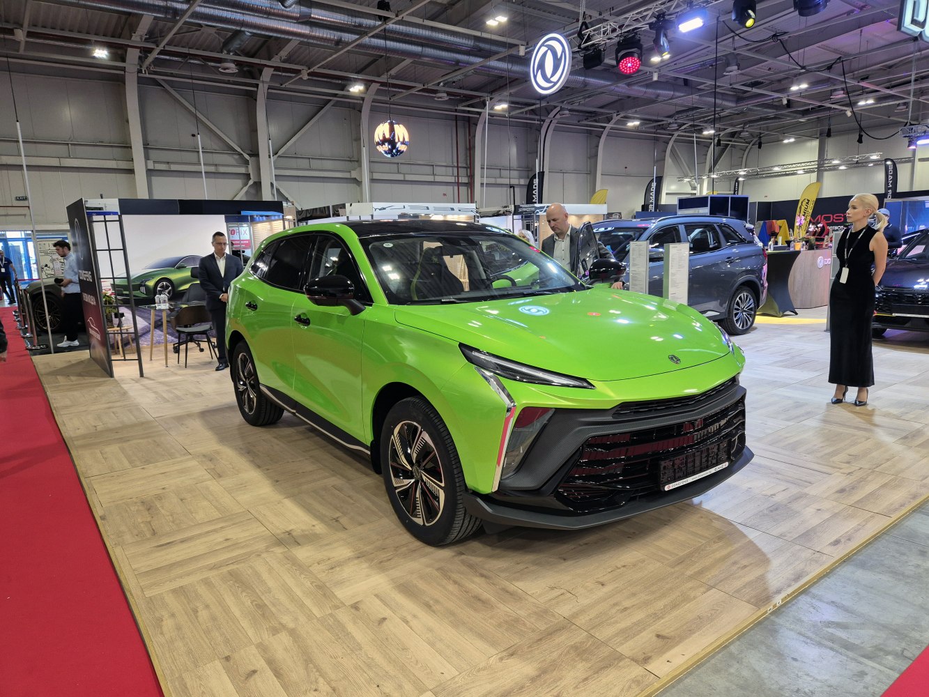 Bright green SUV with sleek front, LED headlights, and alloy wheels