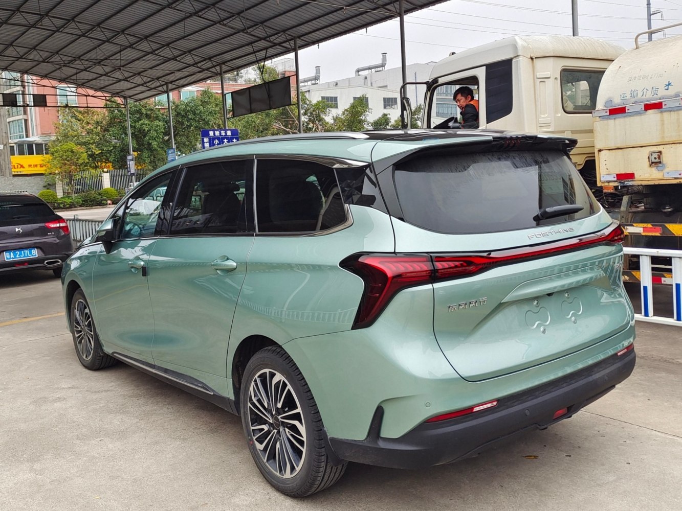 Rear view with sleek connected taillights and alloy wheels