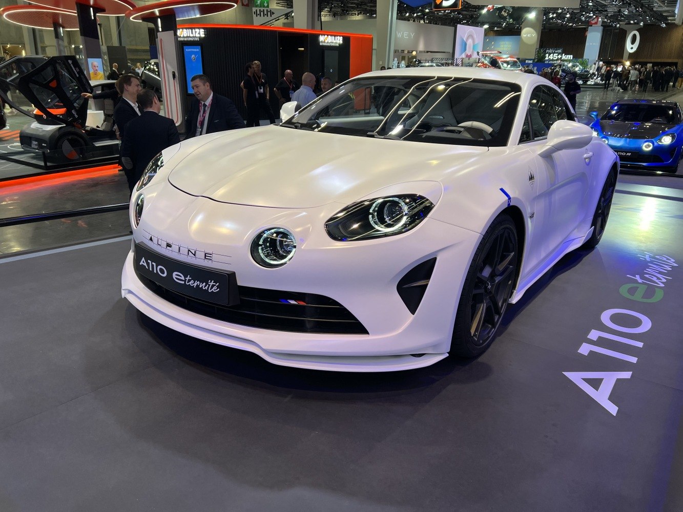 Front end with distinctive round and oval headlights in a white prototype vehicle