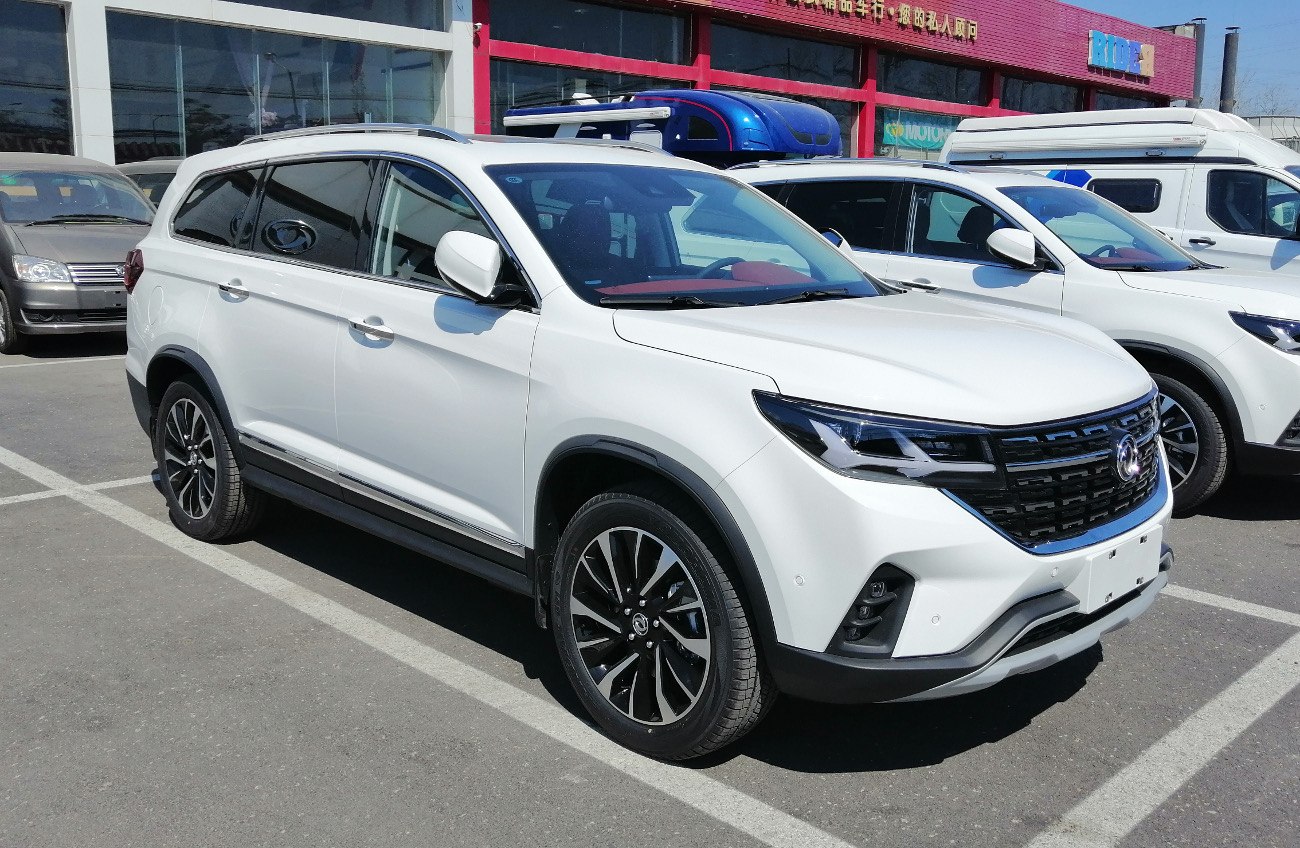 White mid-size SUV front side with sleek headlights and black grille