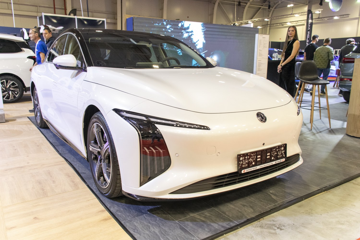 Front and side view with futuristic headlight design and aerodynamic body.
