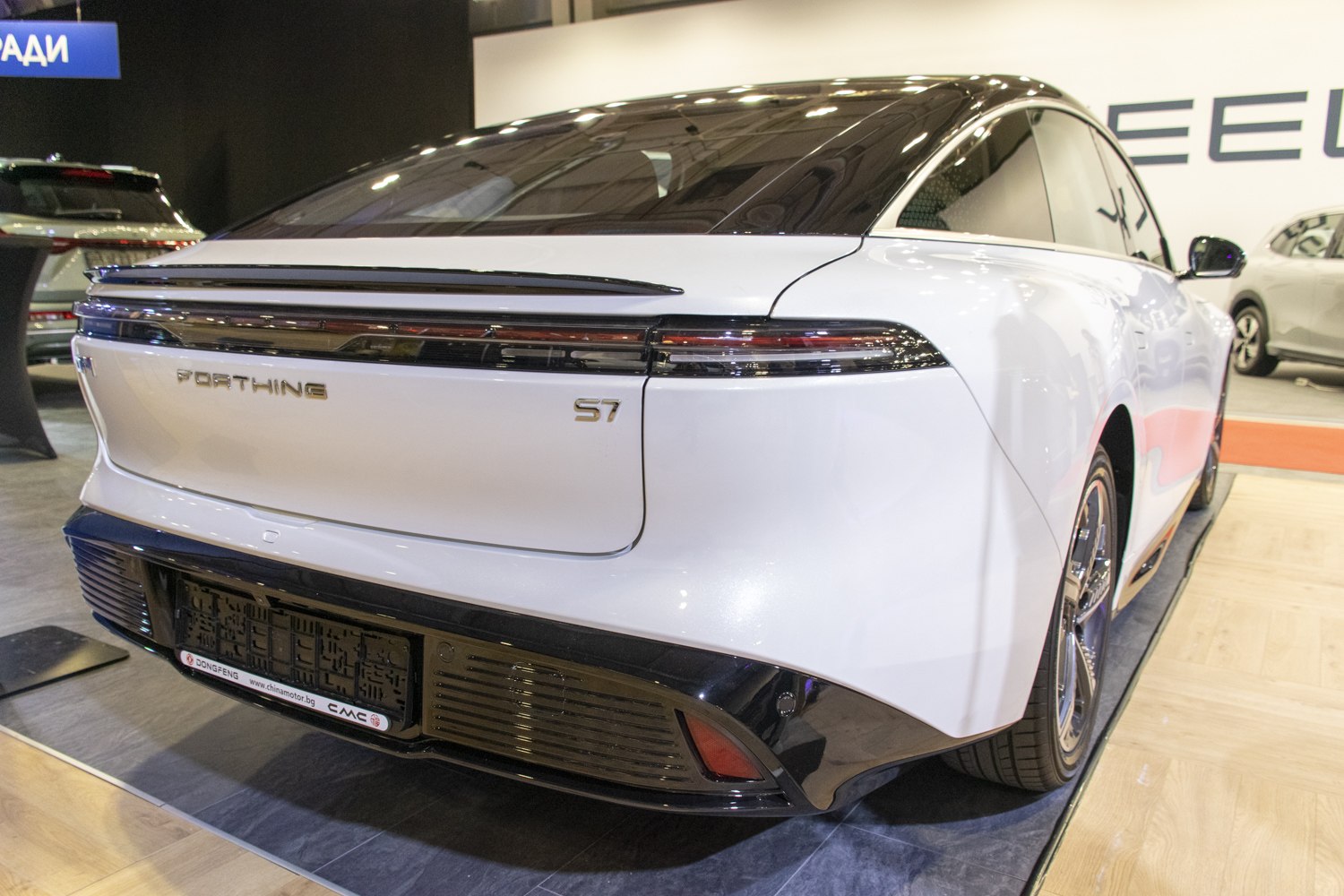 Sleek rear design with integrated tail lights and a black lower bumper section.