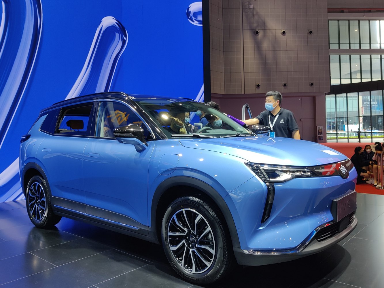 Electric SUV with modern headlights and sporty alloy wheels in blue.
