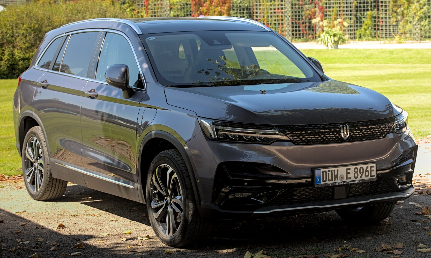 Front three-quarter view of an electric SUV with sleek headlights and modern design