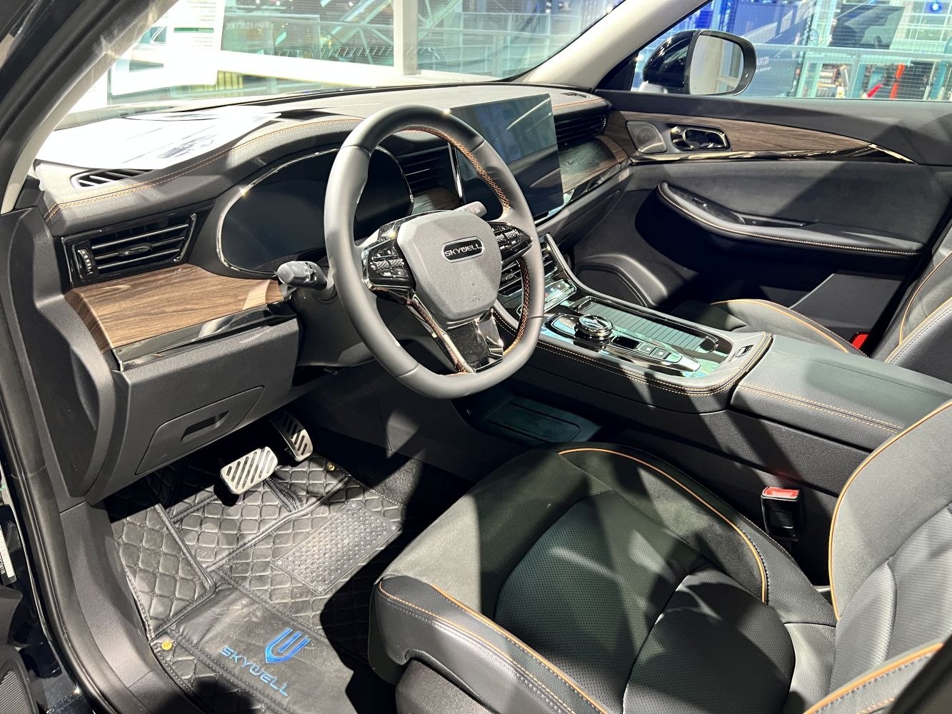 Modern dashboard with touchscreen and leather seats with contrast stitching.