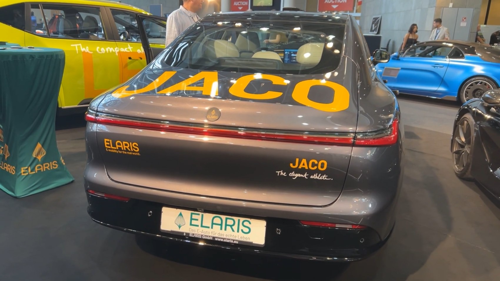 Rear view of sleek electric sedan with modern tail lights and aerodynamic design