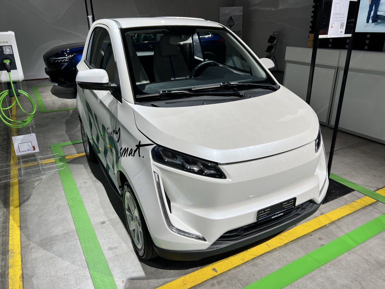 Compact electric vehicle front with sleek headlights and vertical LED daytime running lights