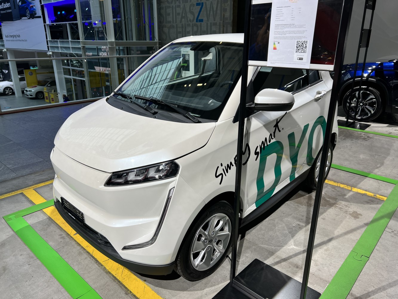 Compact electric vehicle front with sleek headlights and aerodynamic design