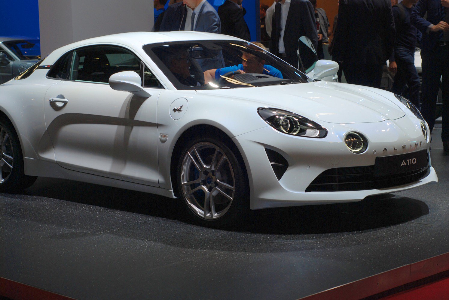 White sporty coupe with quad round headlights and sleek lines