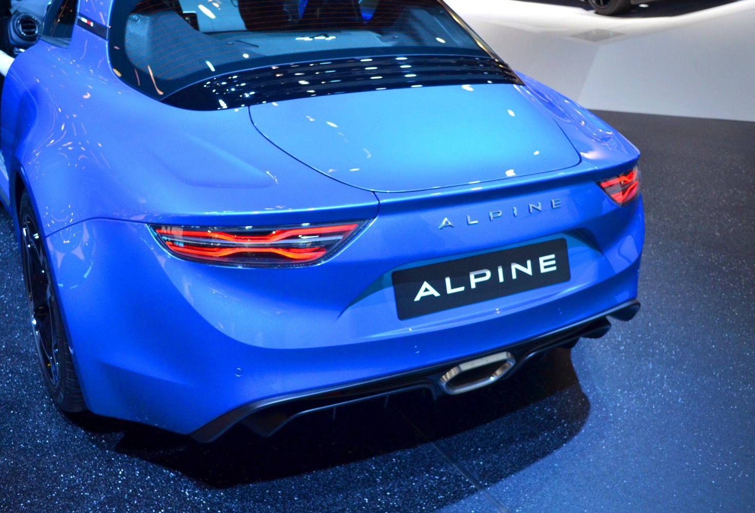 Close-up of Alpine A110 rear with sleek tail lights and central exhaust