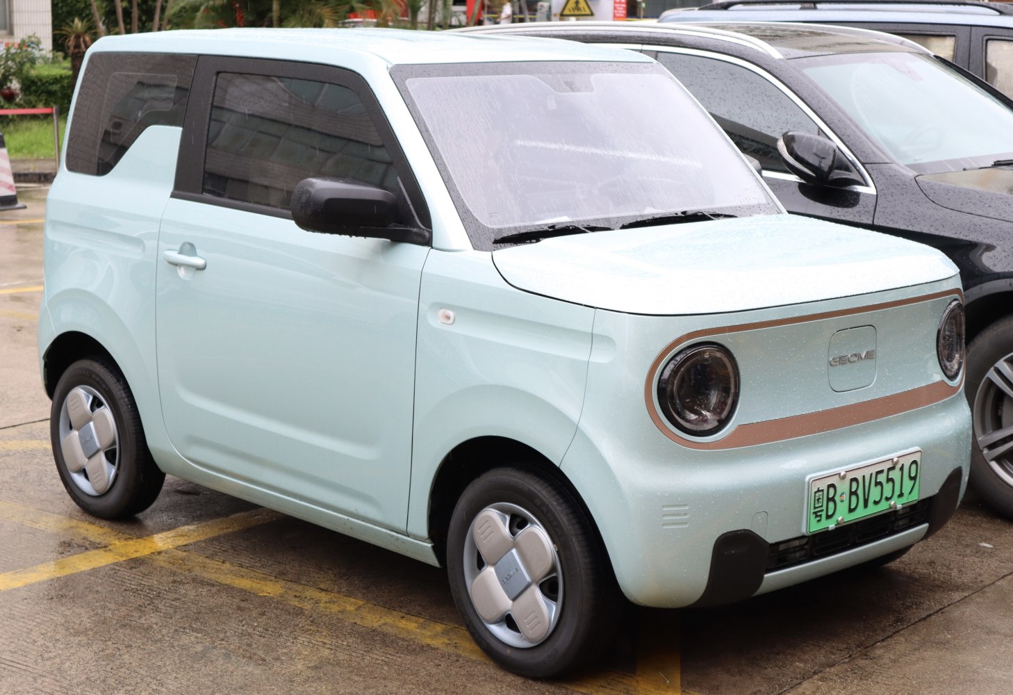 Compact electric vehicle with retro round headlights and minimalistic grille