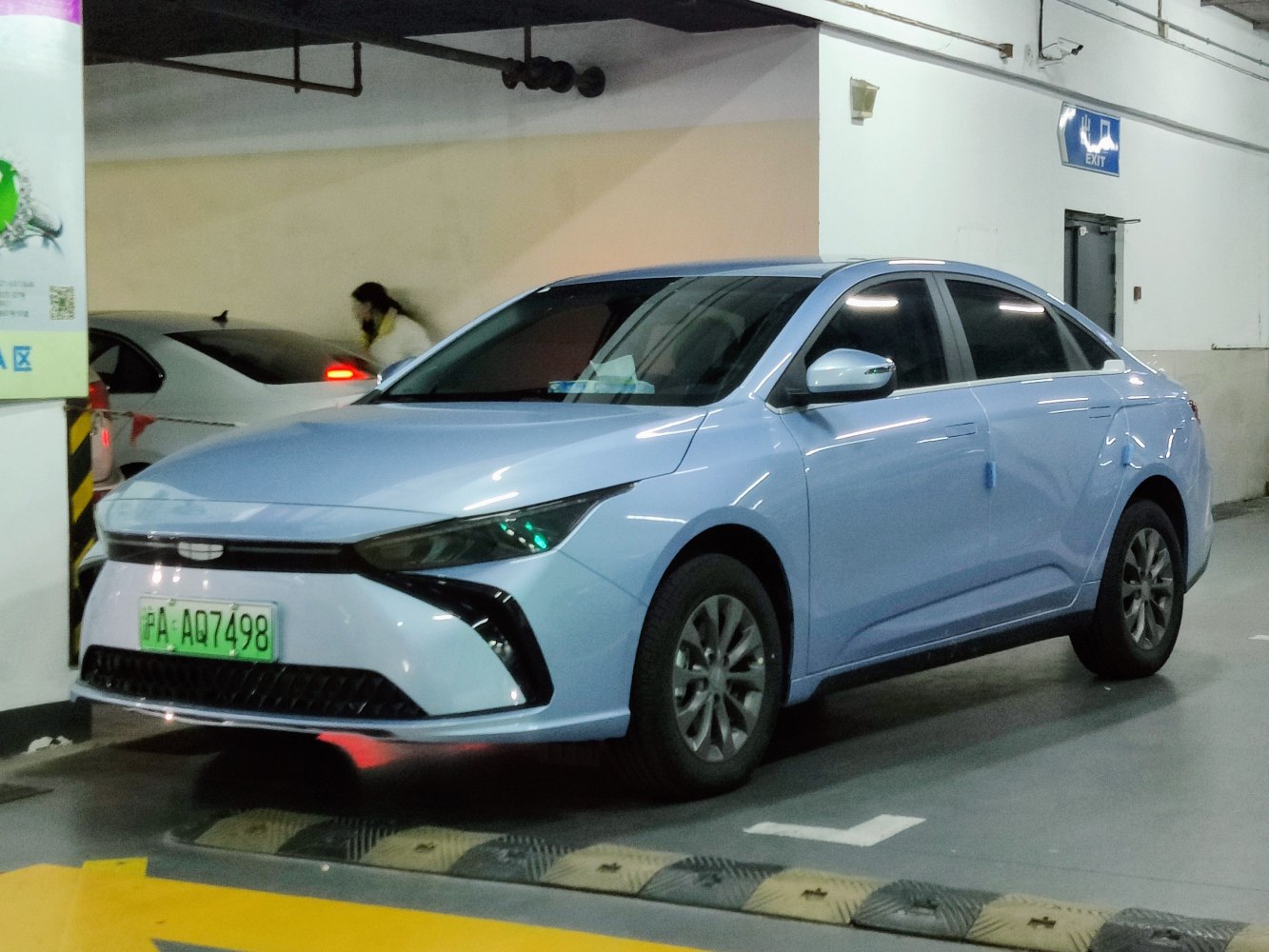 Electric sedan front and side view with sleek headlights and aerodynamic design