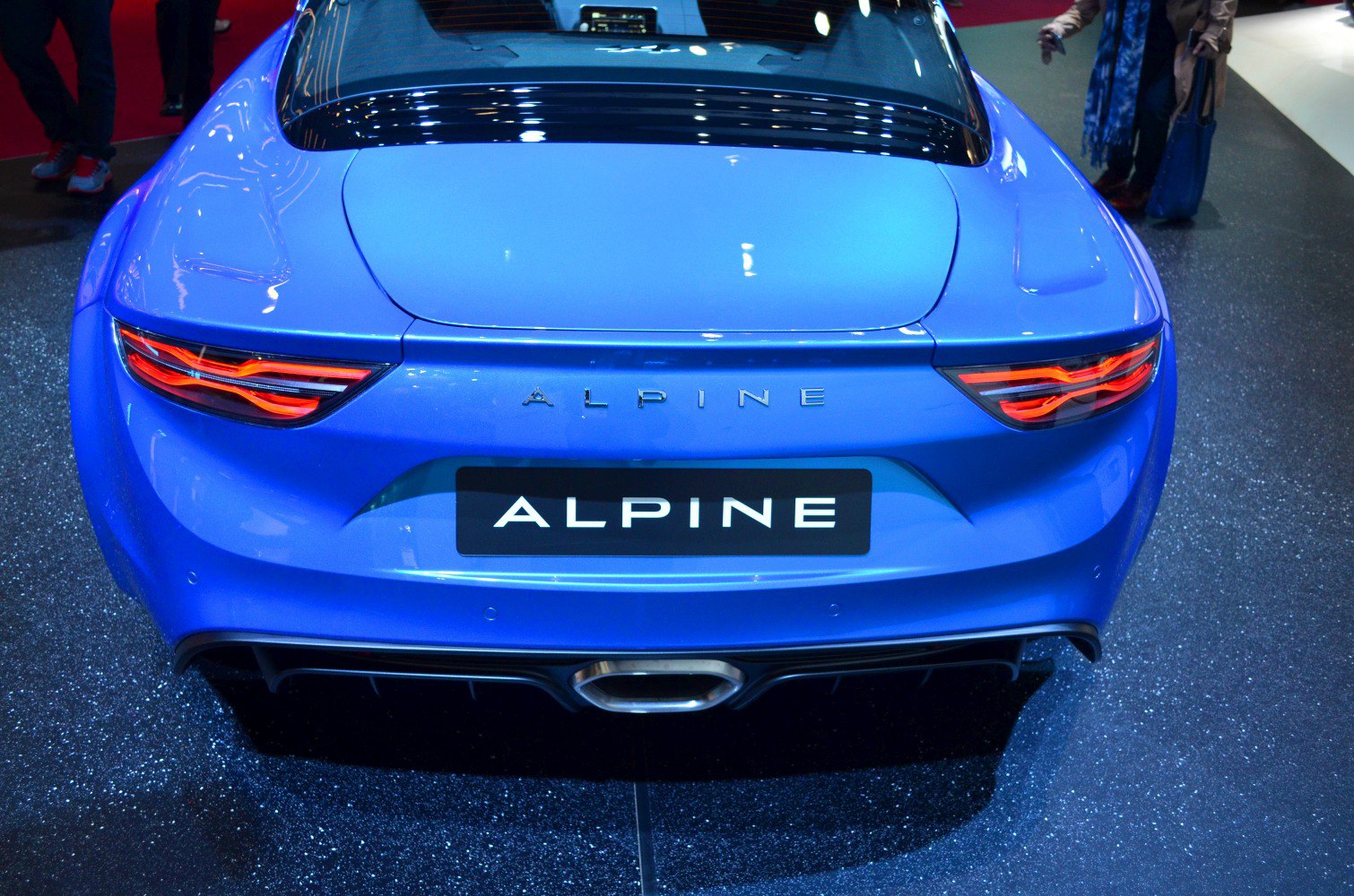 Rear of a sports car with LED tail lights and central exhaust in blue.
