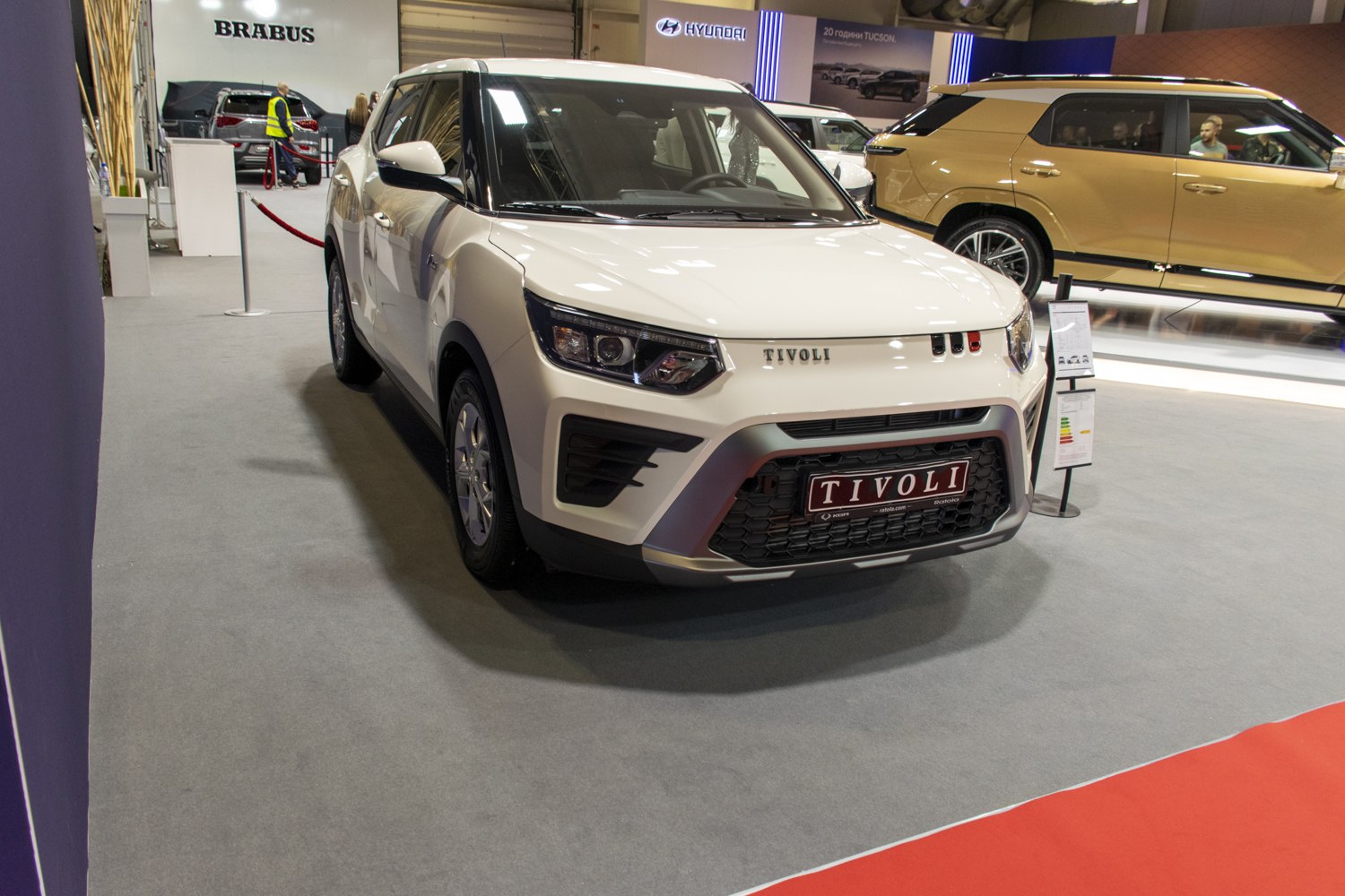 Front view of a compact SUV with LED headlights and hexagonal grille