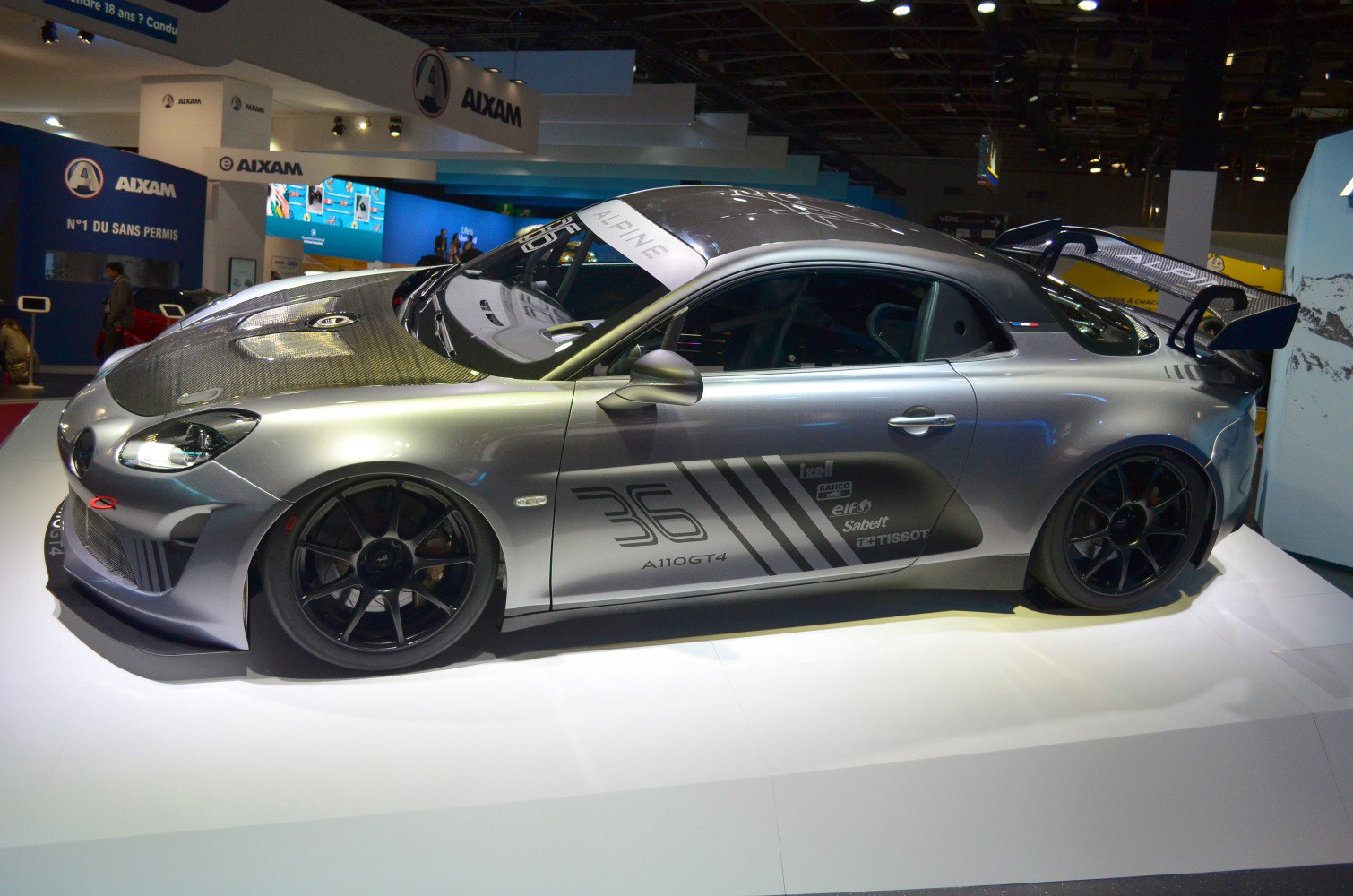 Side profile of Alpine A110 GT4 with carbon fiber hood and large rear wing