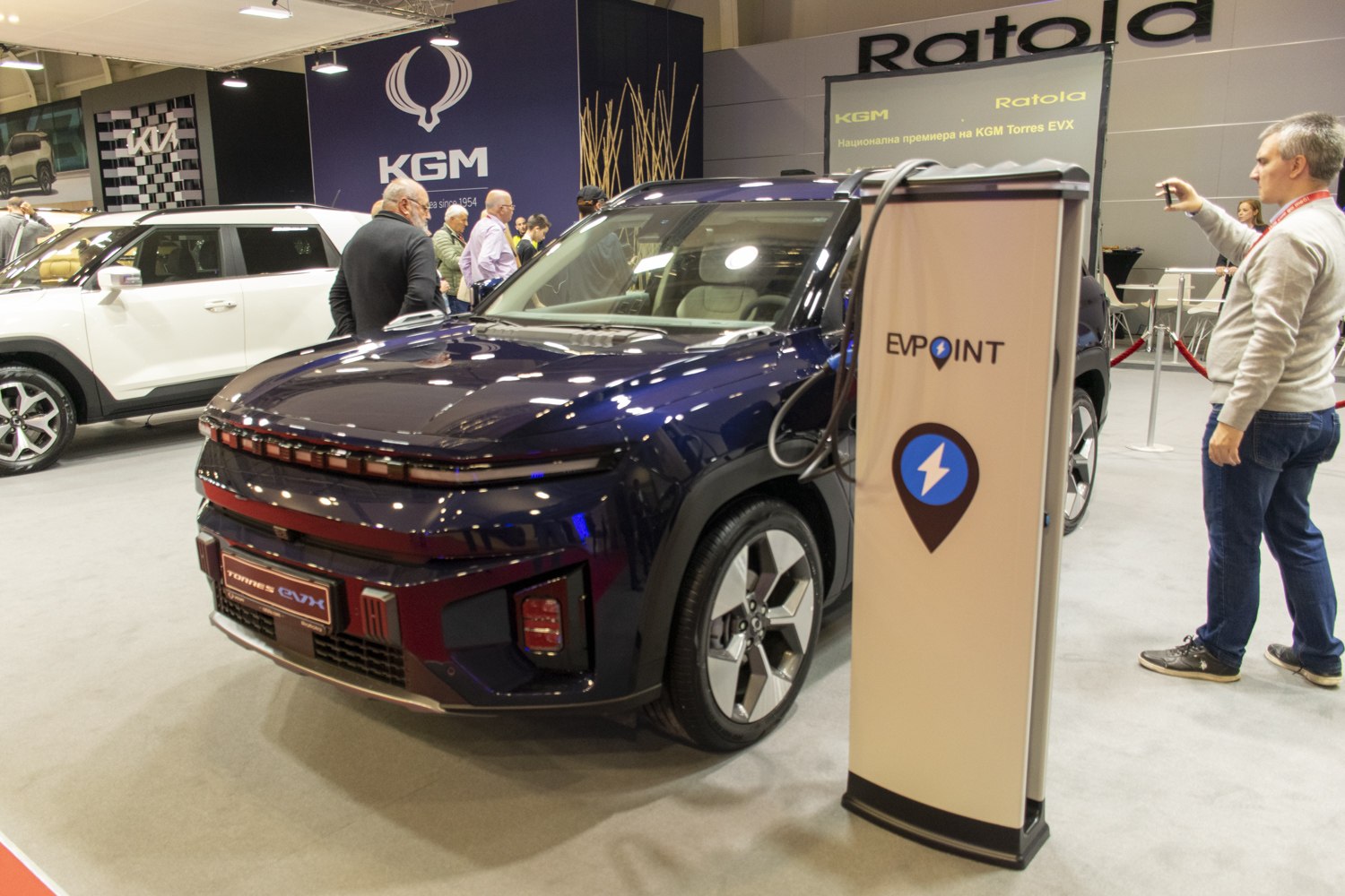 Electric SUV front with horizontal LED lights and charging station