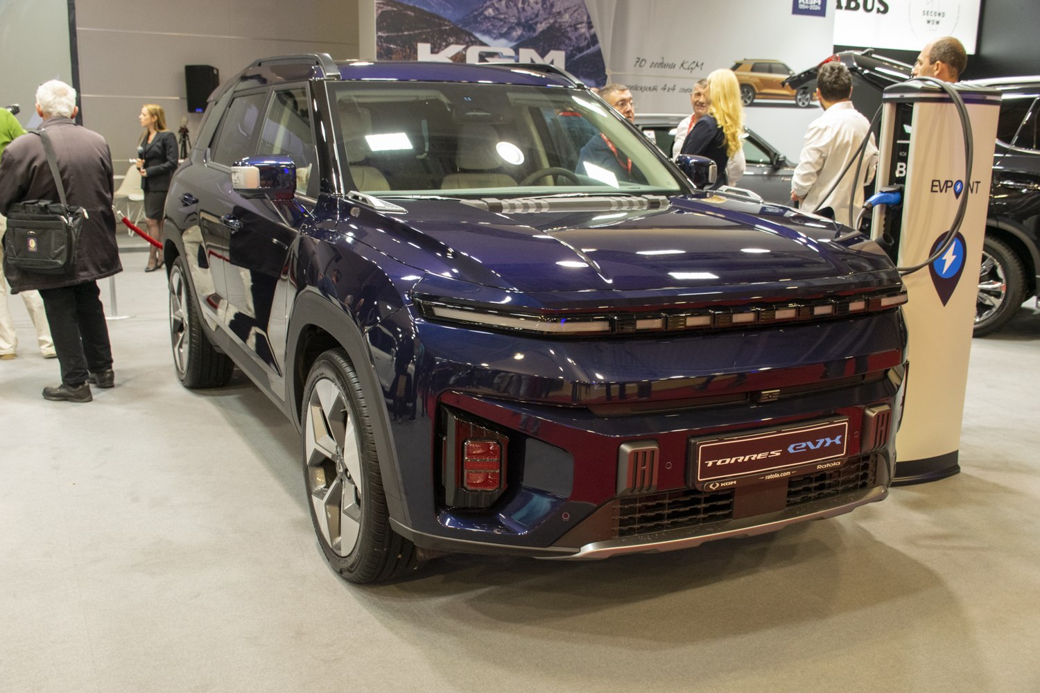 Sleek front view of an electric SUV with distinctive horizontal lighting strip and advanced bumper.
