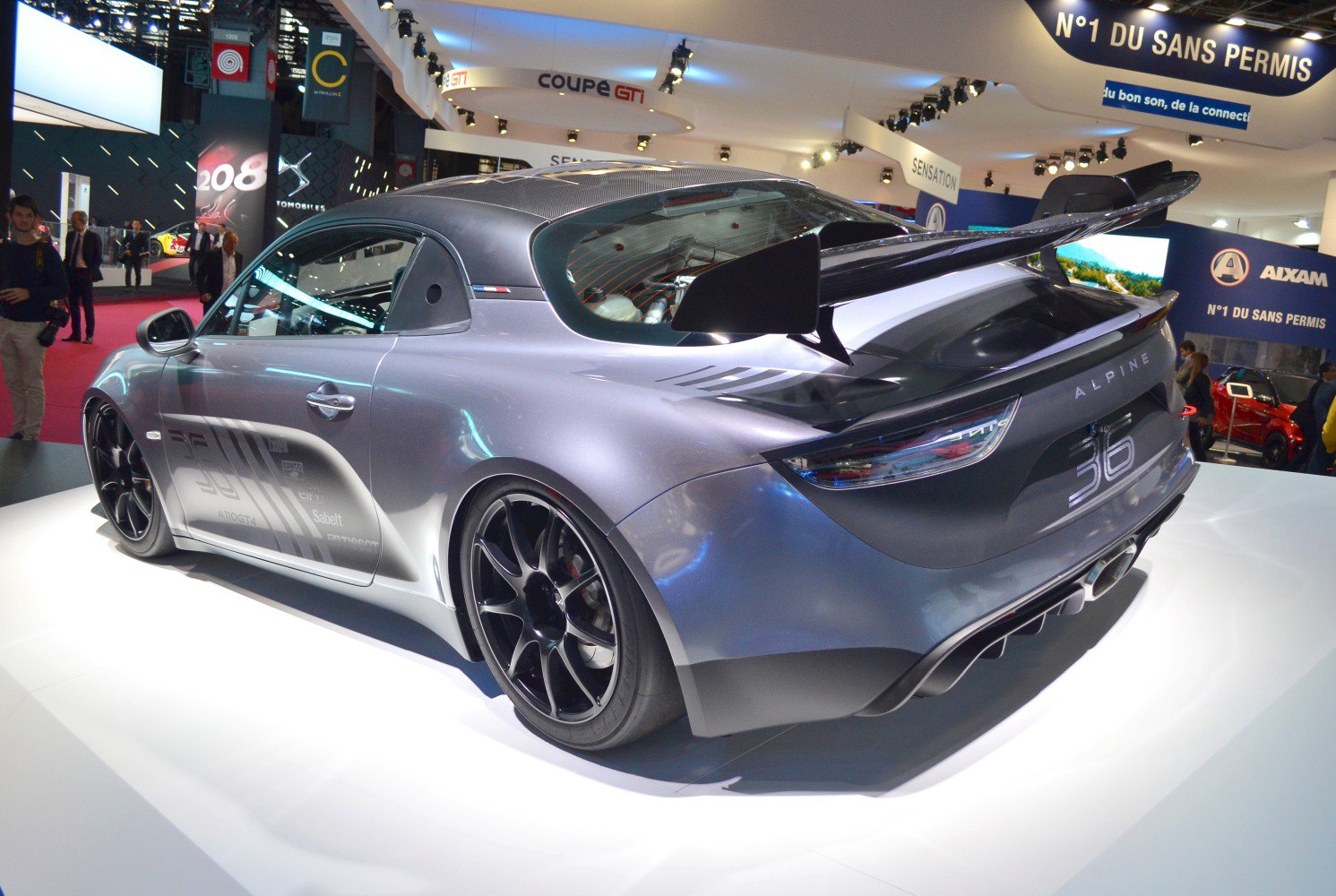 Rear side view with large spoiler and black multi-spoke wheels