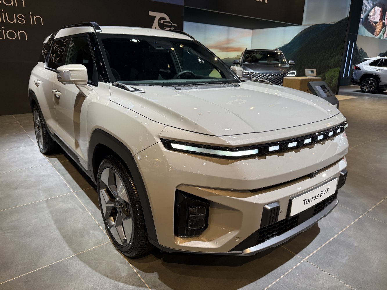 Modern SUV front with horizontal LED daytime running lights and angular bumper design.