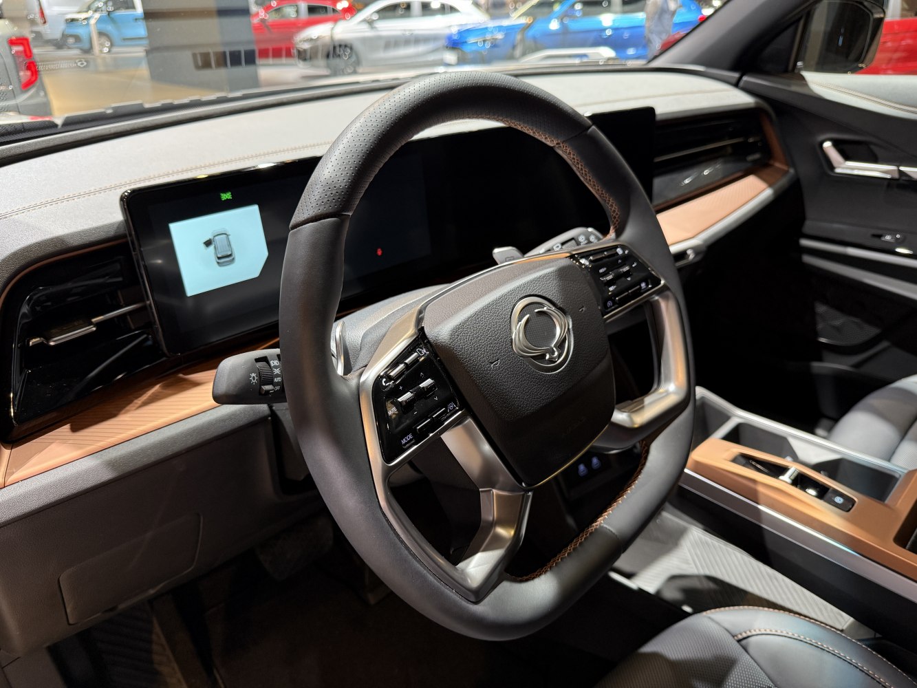 Modern steering wheel with integrated controls and digital dashboard display.