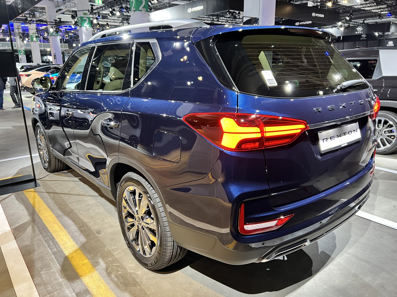 Rear side view of a blue SUV with LED tail lights and alloy wheels