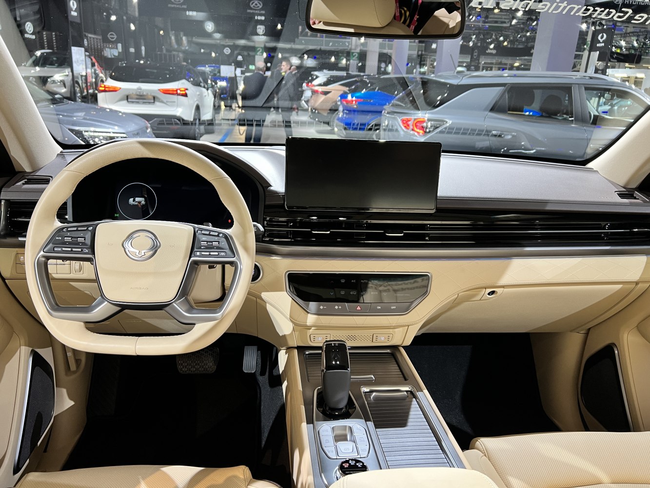 Digital dashboard and multifunction steering wheel with beige interior.