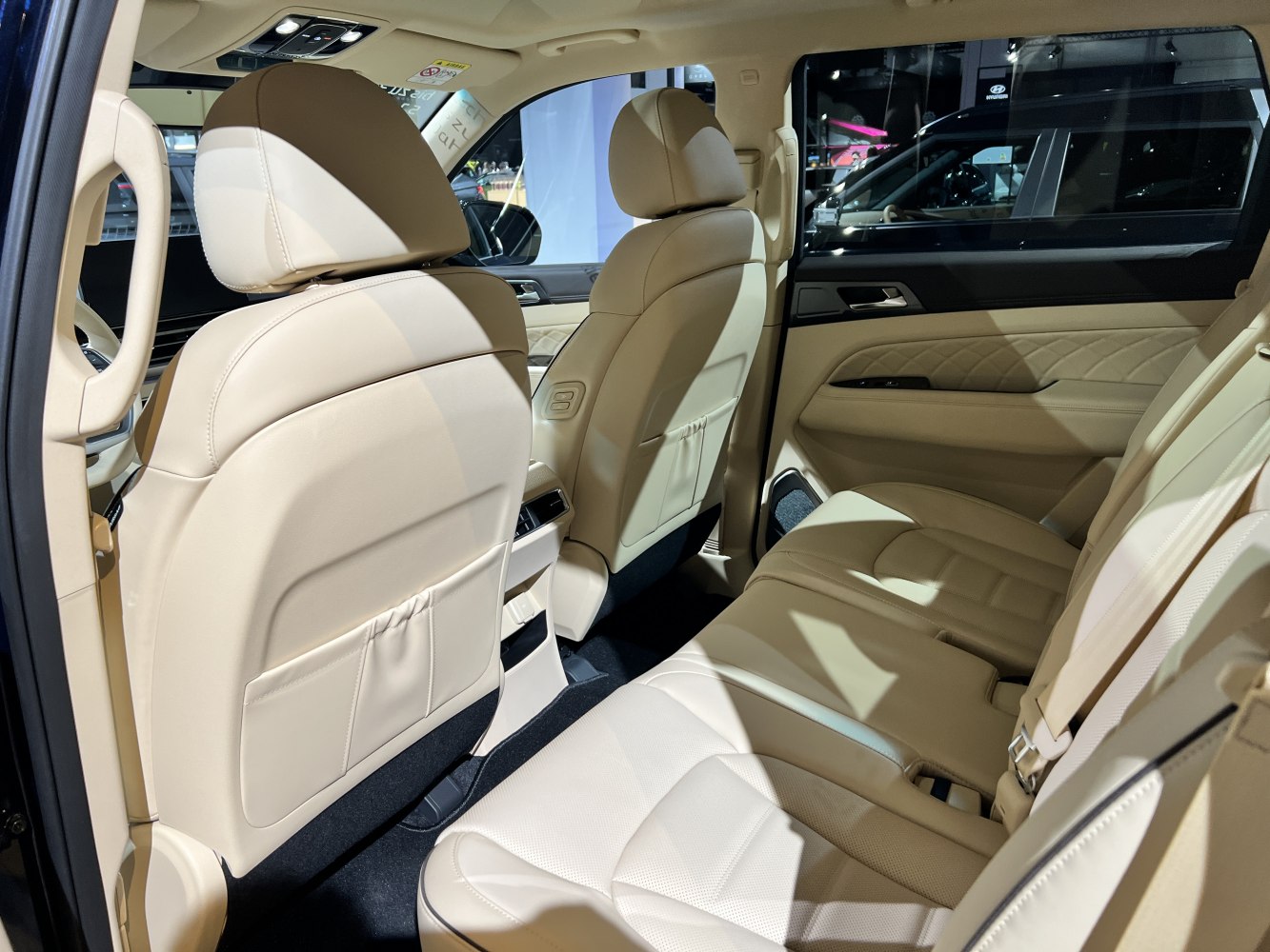 Beige leather rear seats with quilted door panel and spacious legroom