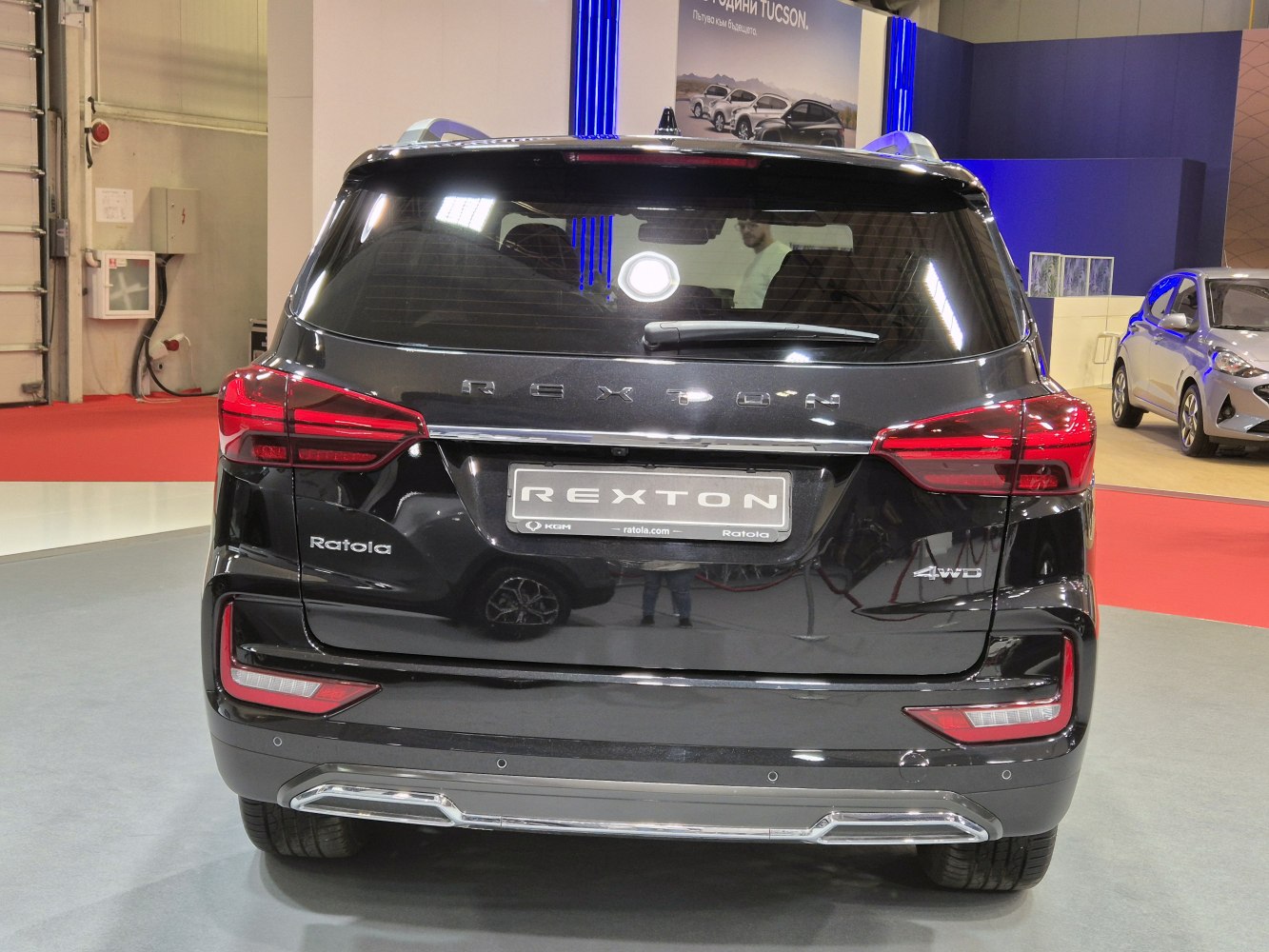 Rear view of SUV with Rexton badge, distinct tail lights, and 4WD emblem