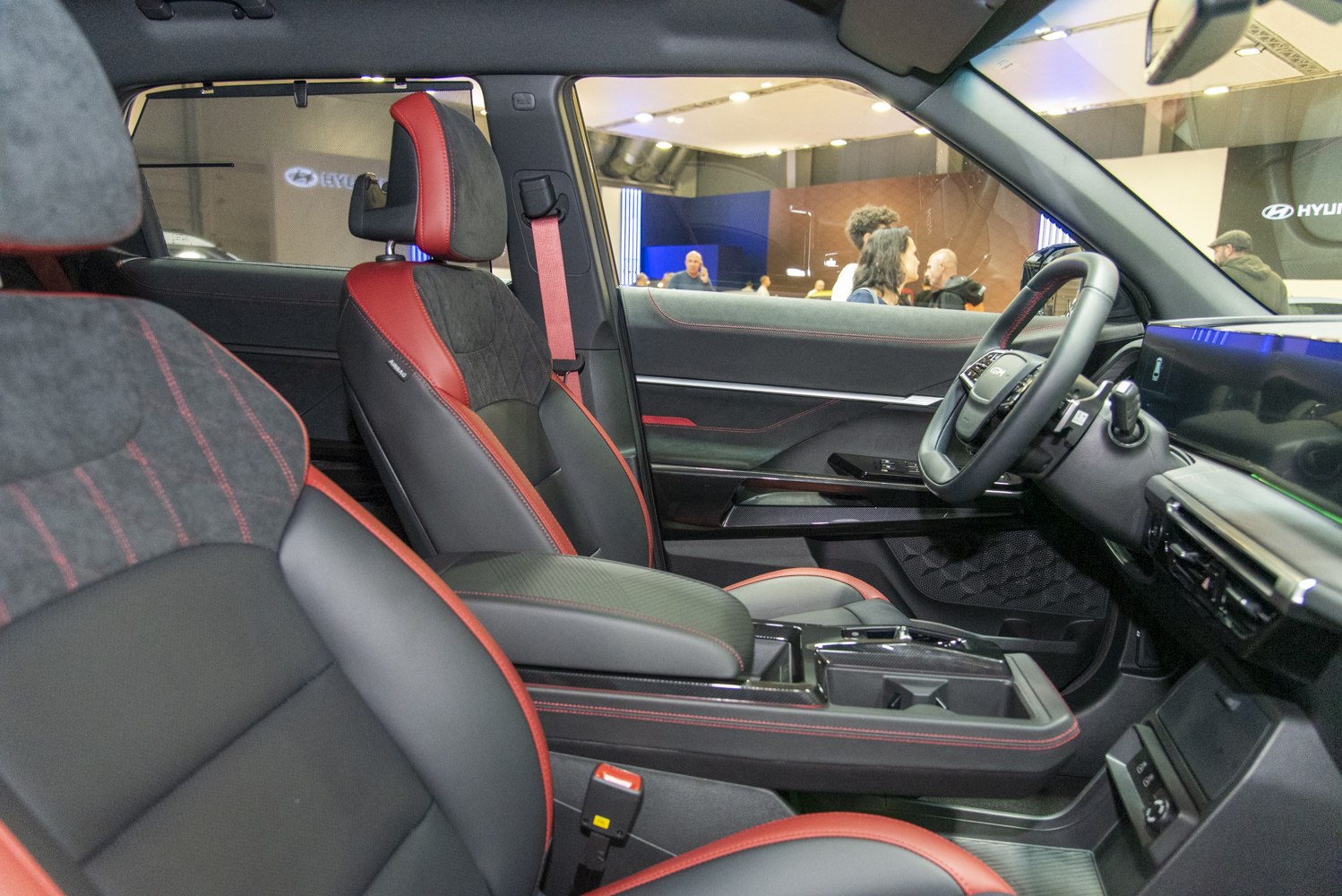 Sporty black and red seats with modern dashboard and controls