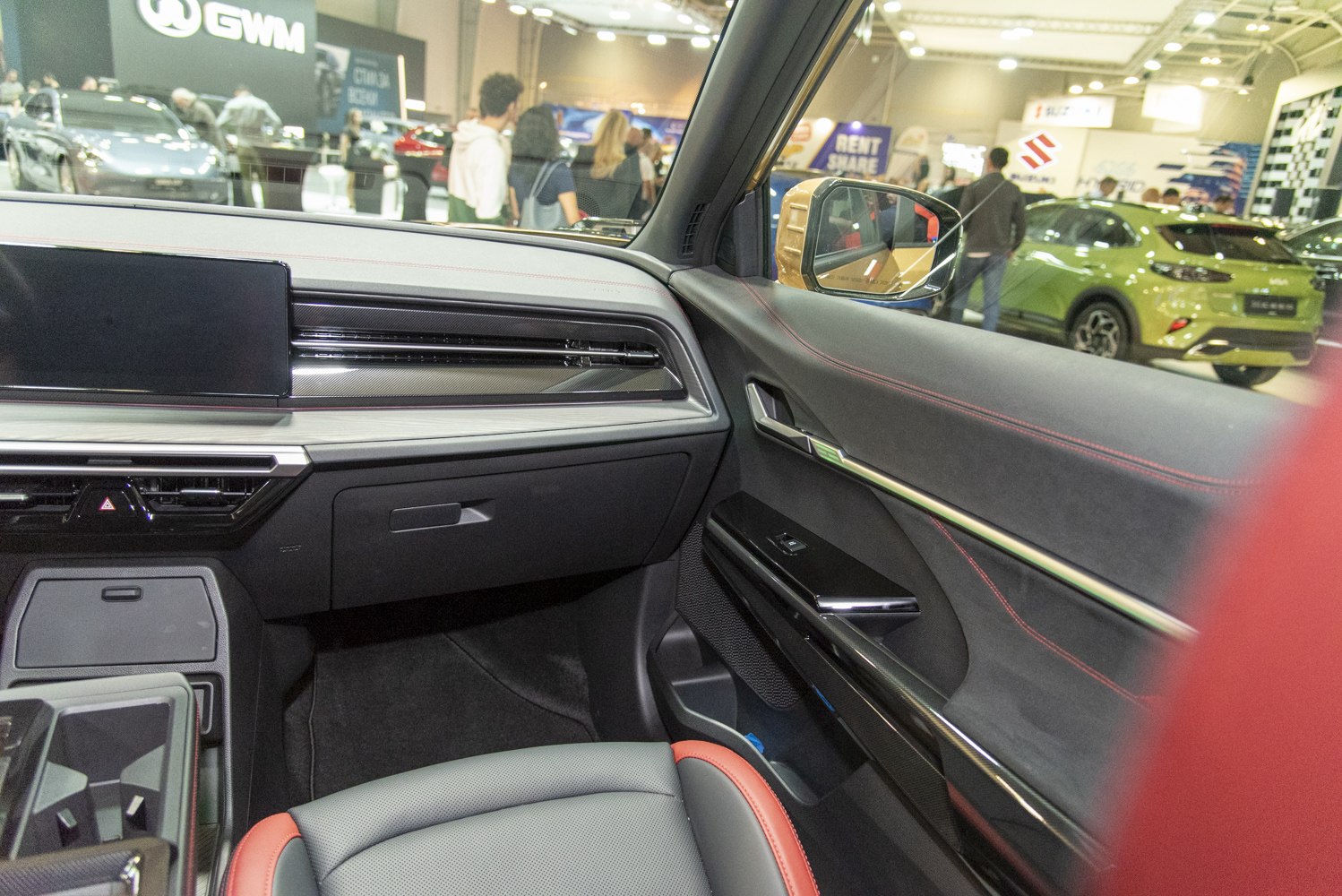 Dashboard with digital display and premium door panel with red stitching