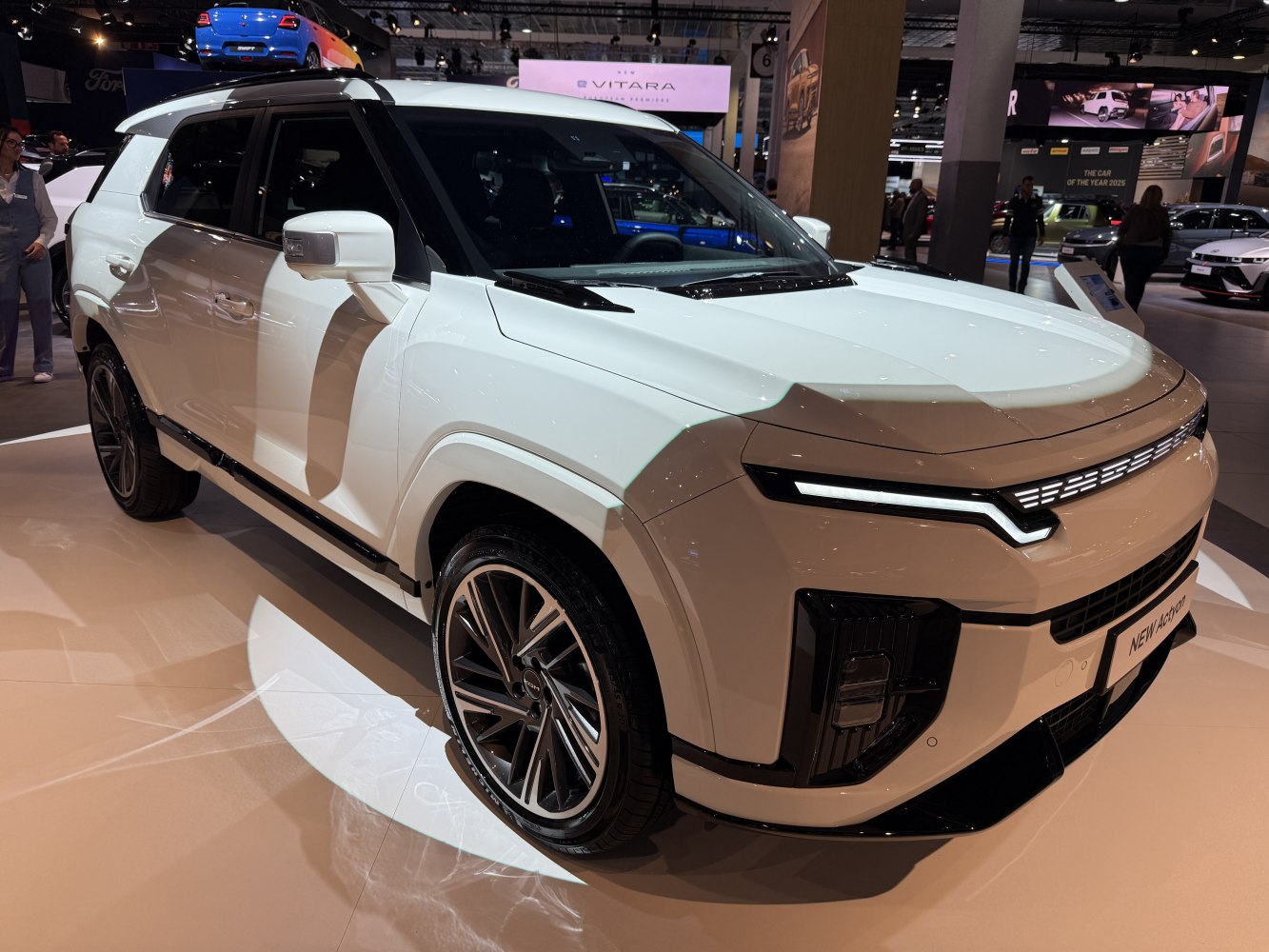 Futuristic LED headlights with alloy wheels on a modern SUV front.