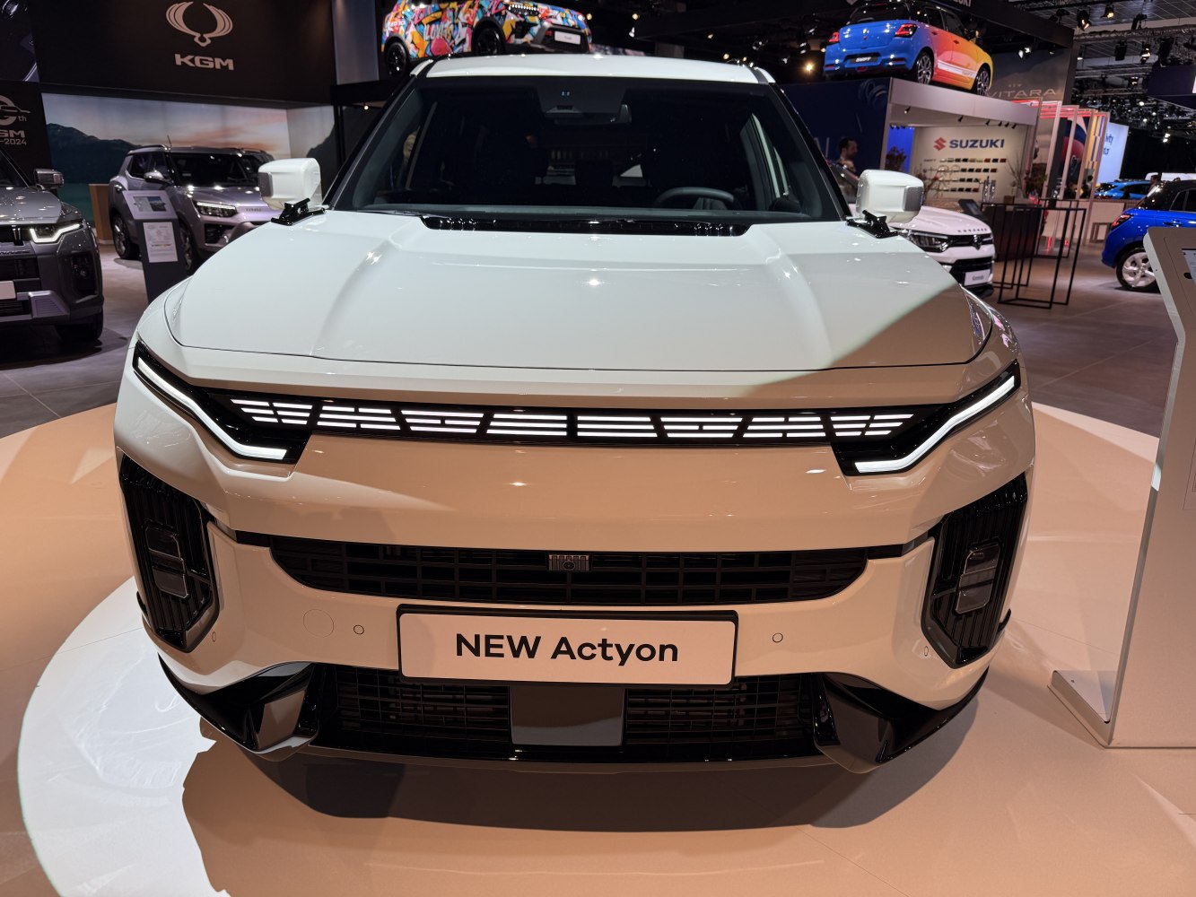 Modern LED headlights and bold grille on white SUV front