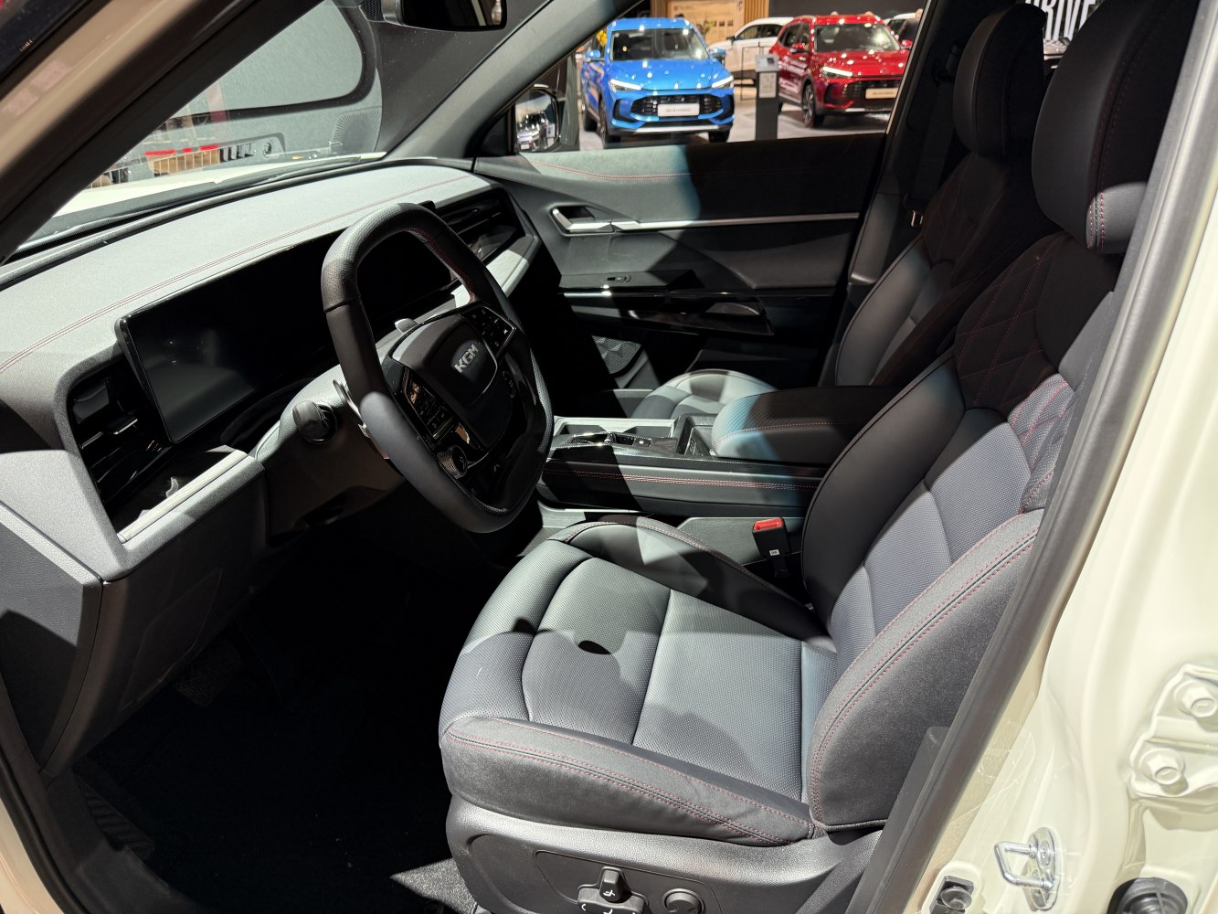 Digital dashboard and leather front seats with red stitching