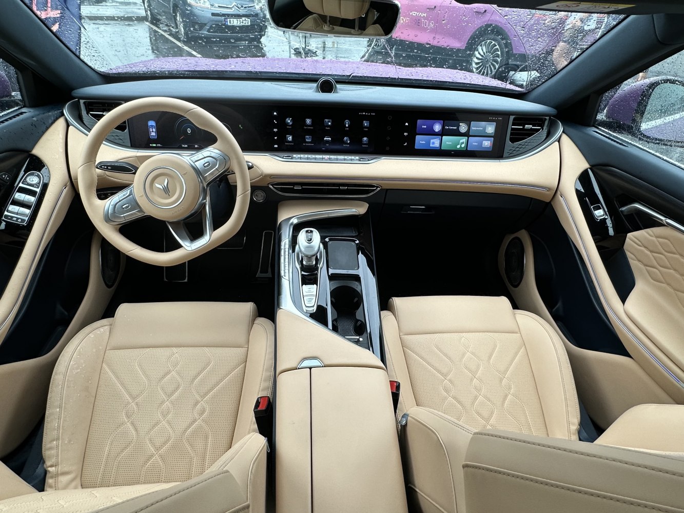 Beige leather seats, digital dashboard, ergonomic steering wheel with touch controls