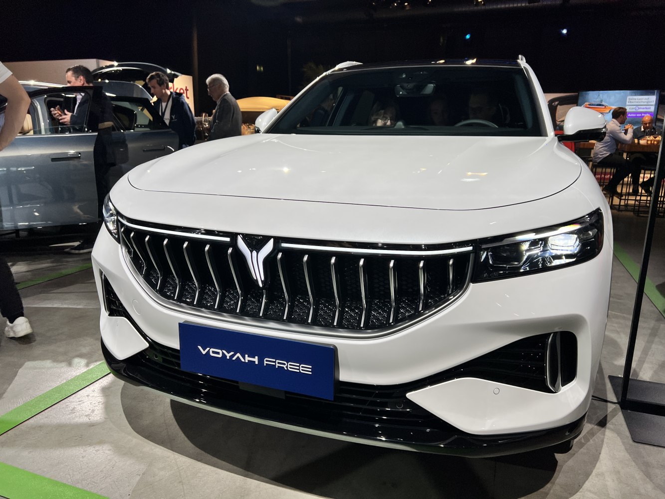 Front grille and LED headlights of a modern white vehicle