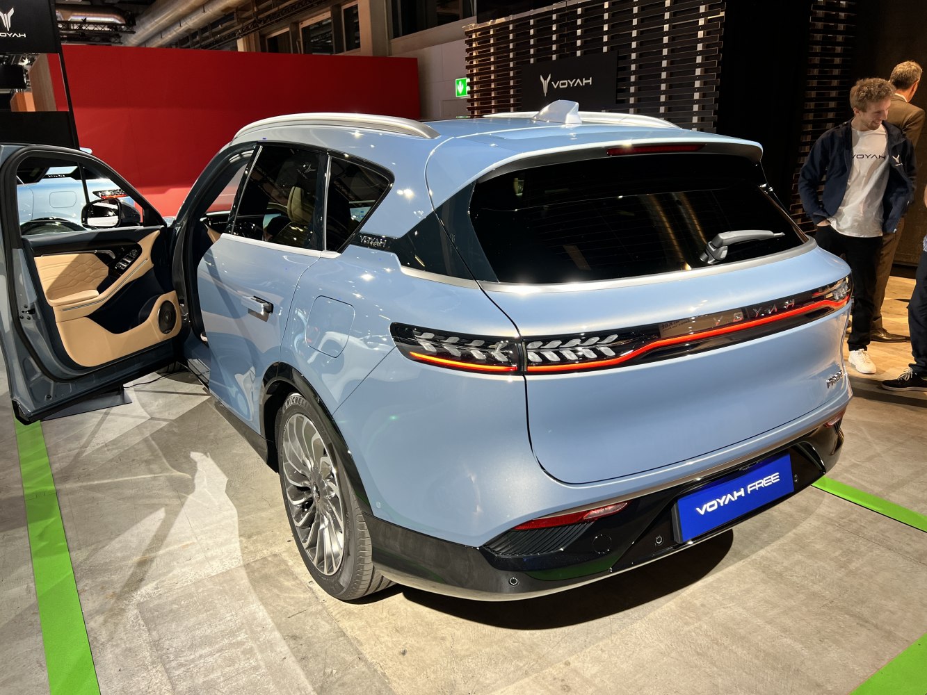 Rear view and interior door of modern electric SUV with sleek taillights and luxury door panel