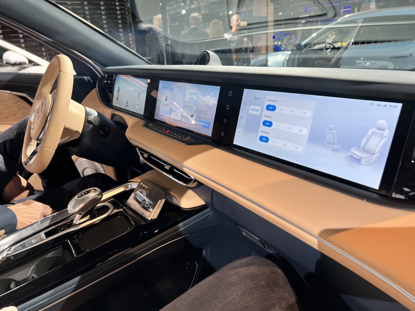 Triple digital screens and modern control layout in luxury car interior