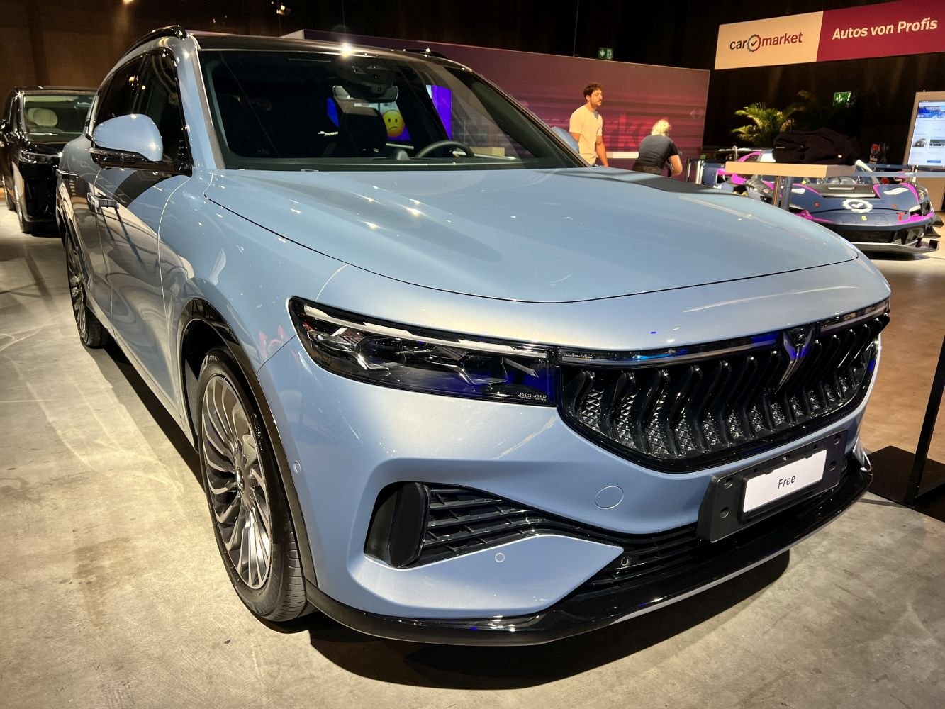 Sleek SUV front with prominent grille and aerodynamic headlight design