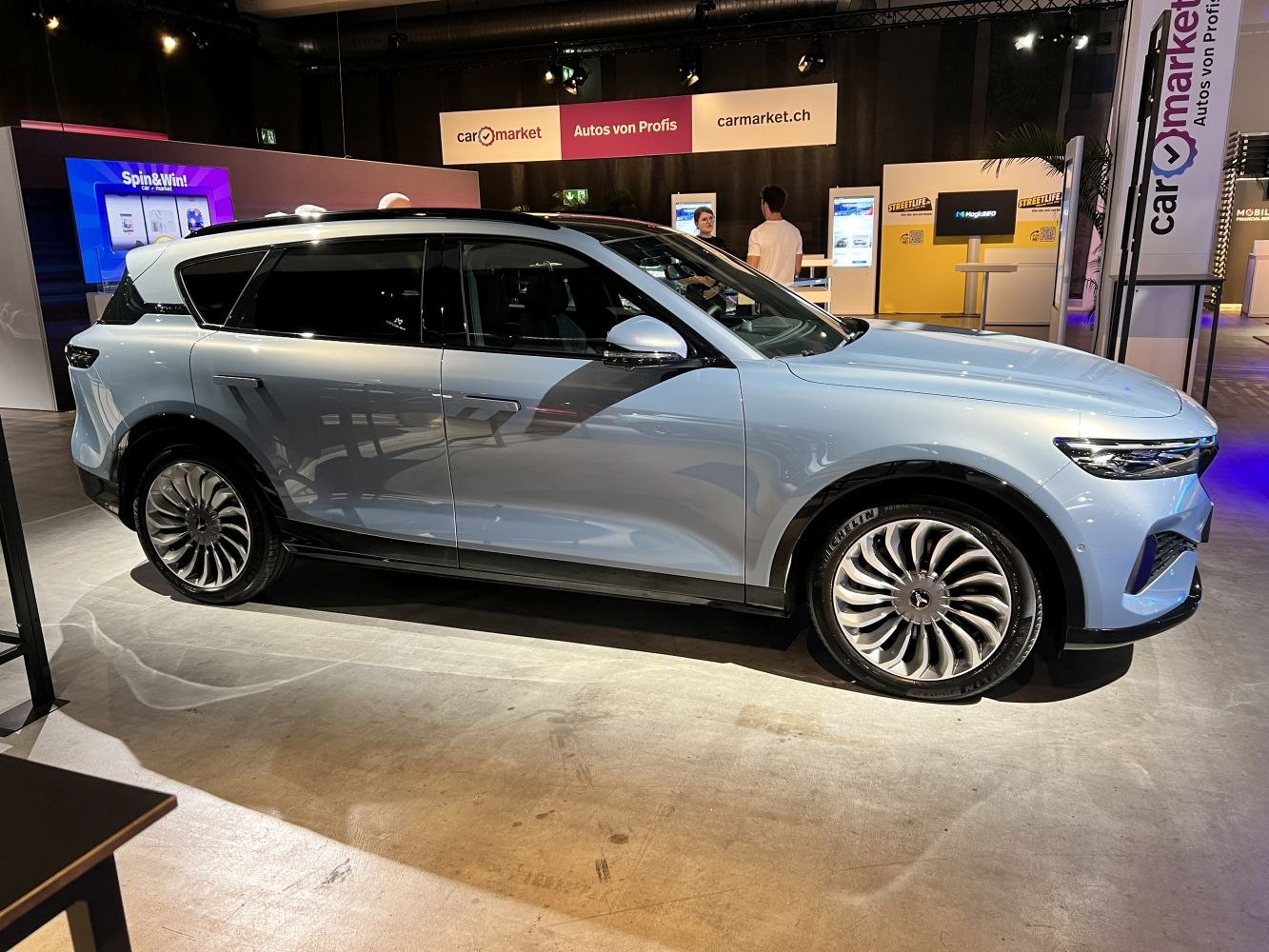 Side profile of an electric SUV with distinctive multi-spoke wheel design.
