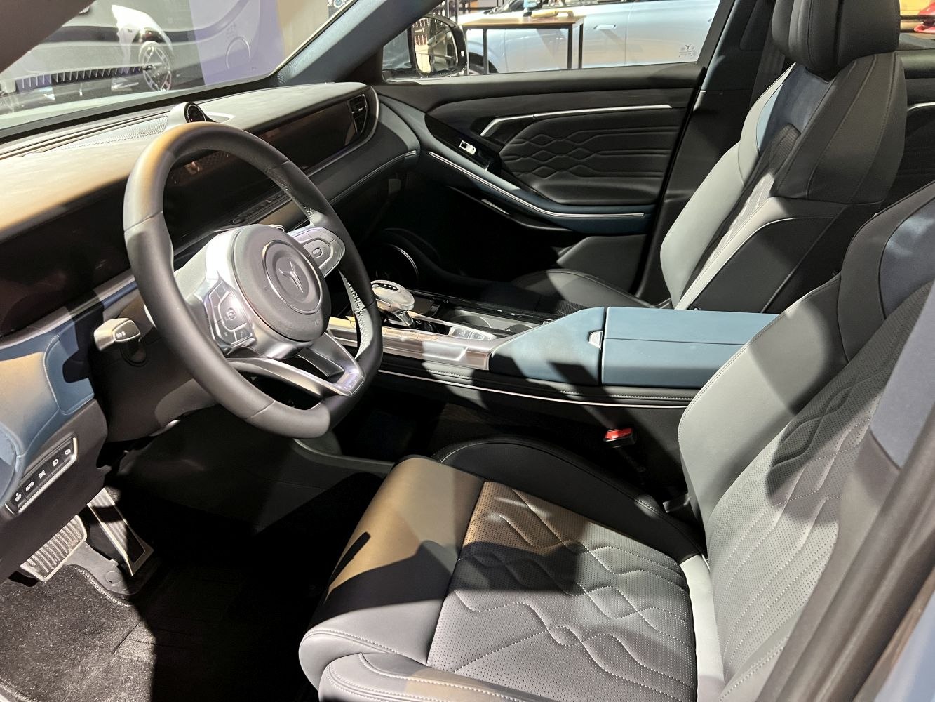 Modern dashboard and luxury perforated leather seats in car interior