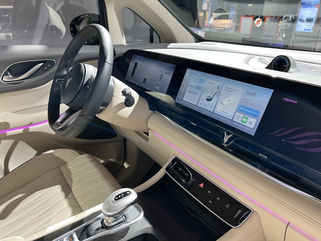 Dual widescreen digital displays and ambient purple lighting with modern interior design