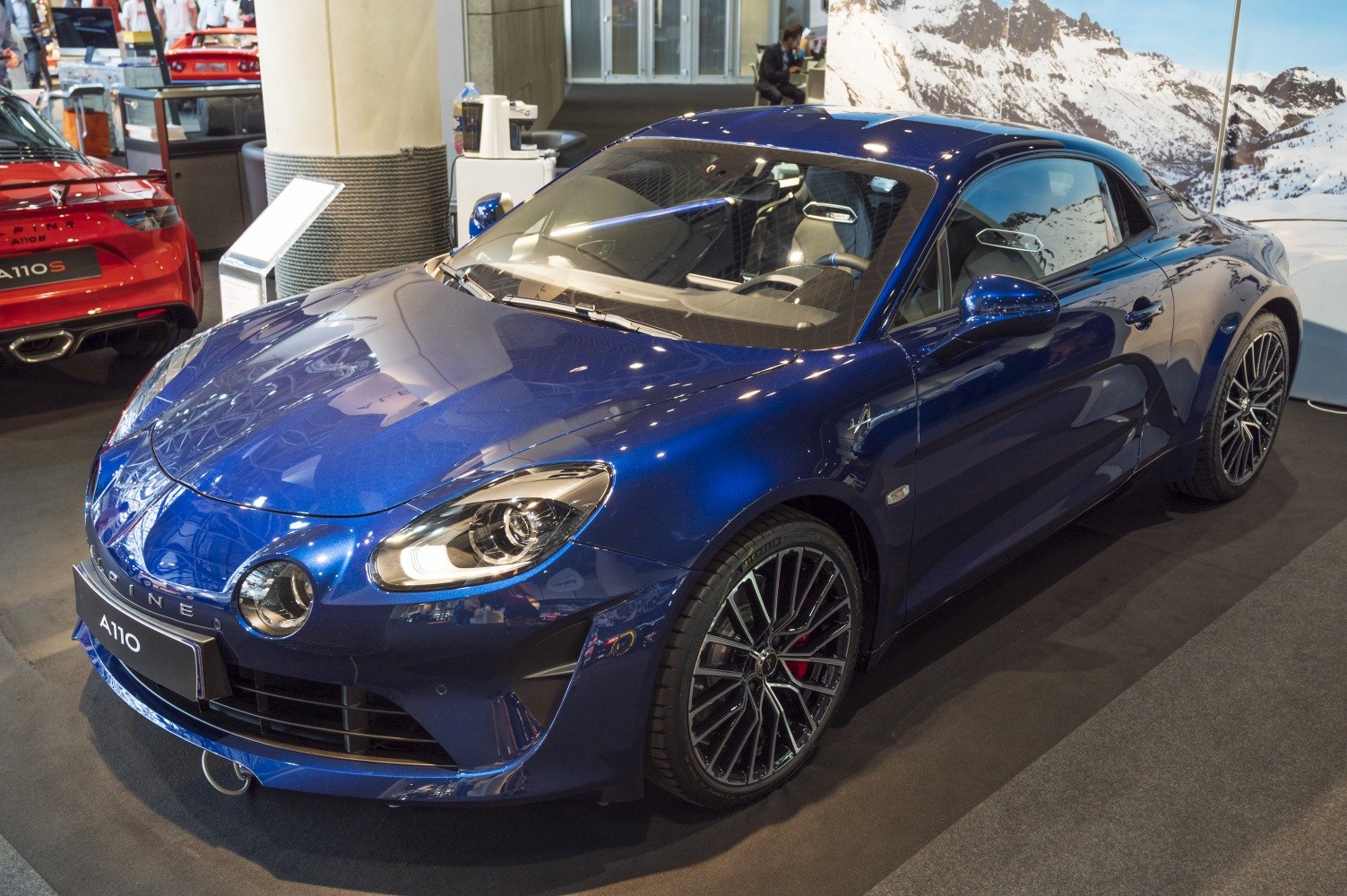 Blue sports coupe with distinctive quad headlights and stylish alloy wheels.